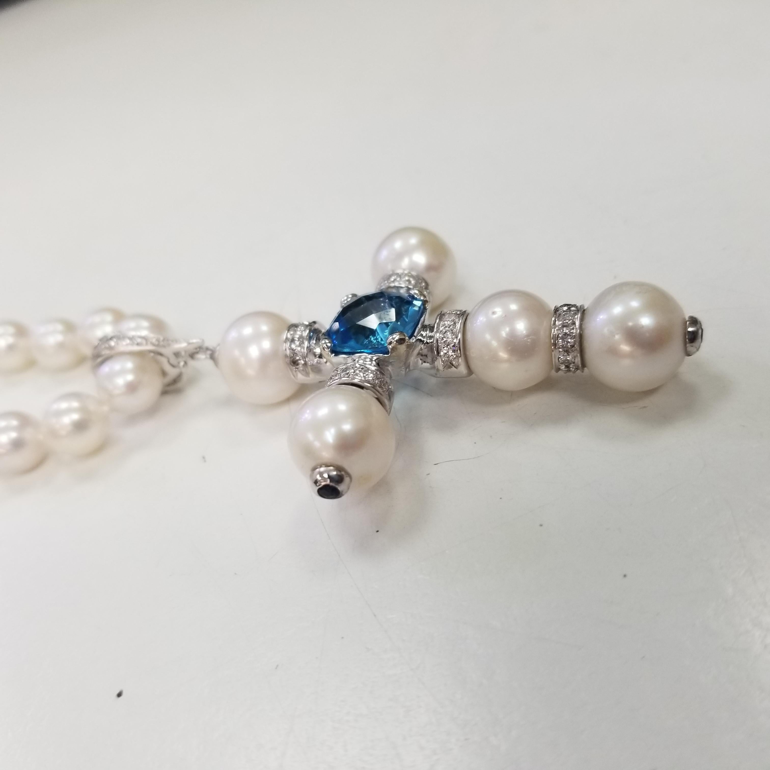 Contemporary 14 Karat White Gold South Sea Pearl Cross with a Swiss Blue Topaz and Diamonds For Sale