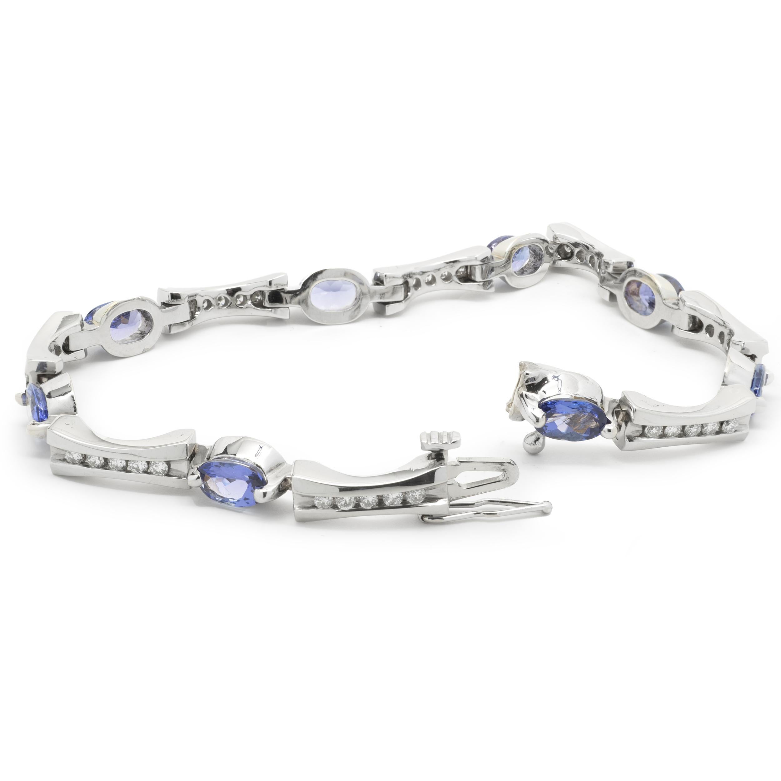 Designer: custom
Material: 14K white gold
Diamonds: 40 round brilliant cut = 0.40cttw
Color: G
Clarity: SI1
Tanzanite: 8 oval cut = 4.56cttw
Dimensions: bracelet will fit up to an 6.5-inch wrist
Weight: 14.69 grams
