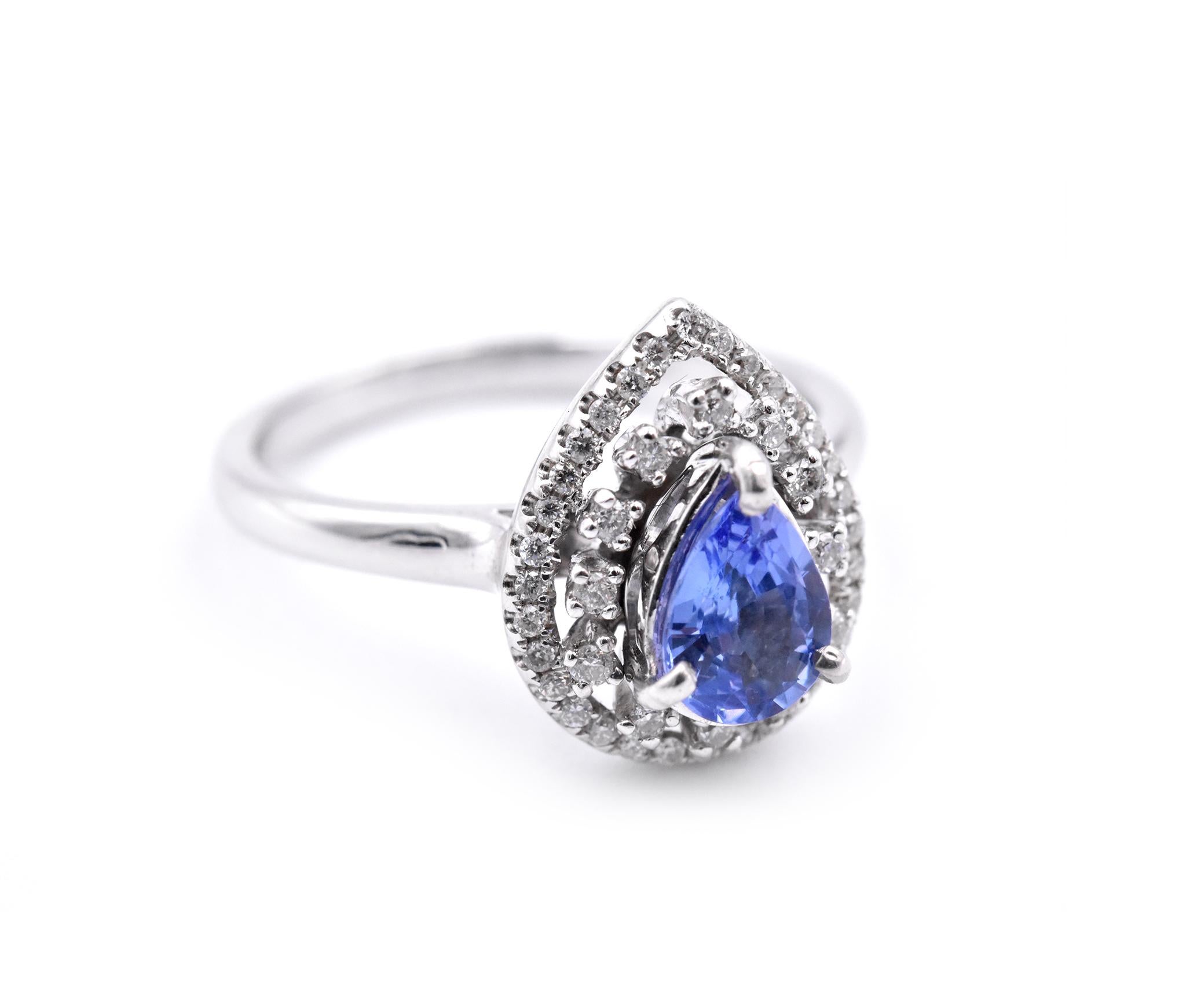 Designer: custom design
Material: 14k white gold
Gemstones: Tanzanite = .85ct PEAR
Certification: AGI 26001
Diamonds: 44 round brilliant cuts = .33cttw
Color: F/G
Clarity: VS-SI
Ring Size: 7.5 (please allow two additional shipping days for sizing