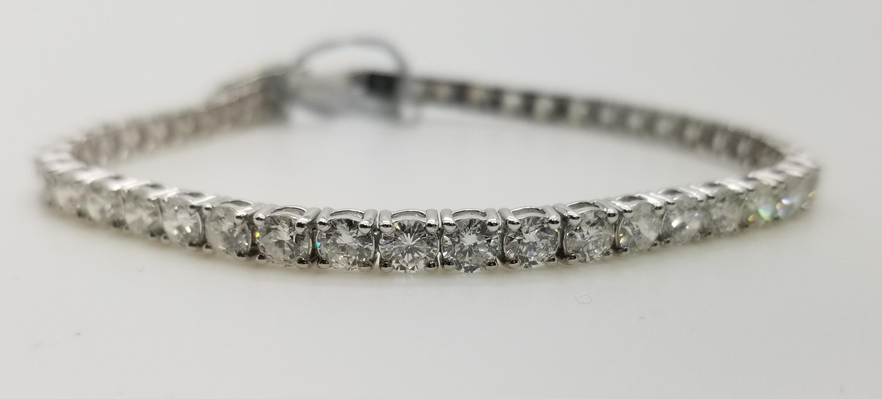 This is very beautiful 14k white gold custom made tennis bracelet with 45 round diamonds color F-G and clarity SI1 weighing 9.01cts. very fine quality diamonds, bracelet measures 7 inches with clasp and safety.
Specifications:
    main stone: ROUND