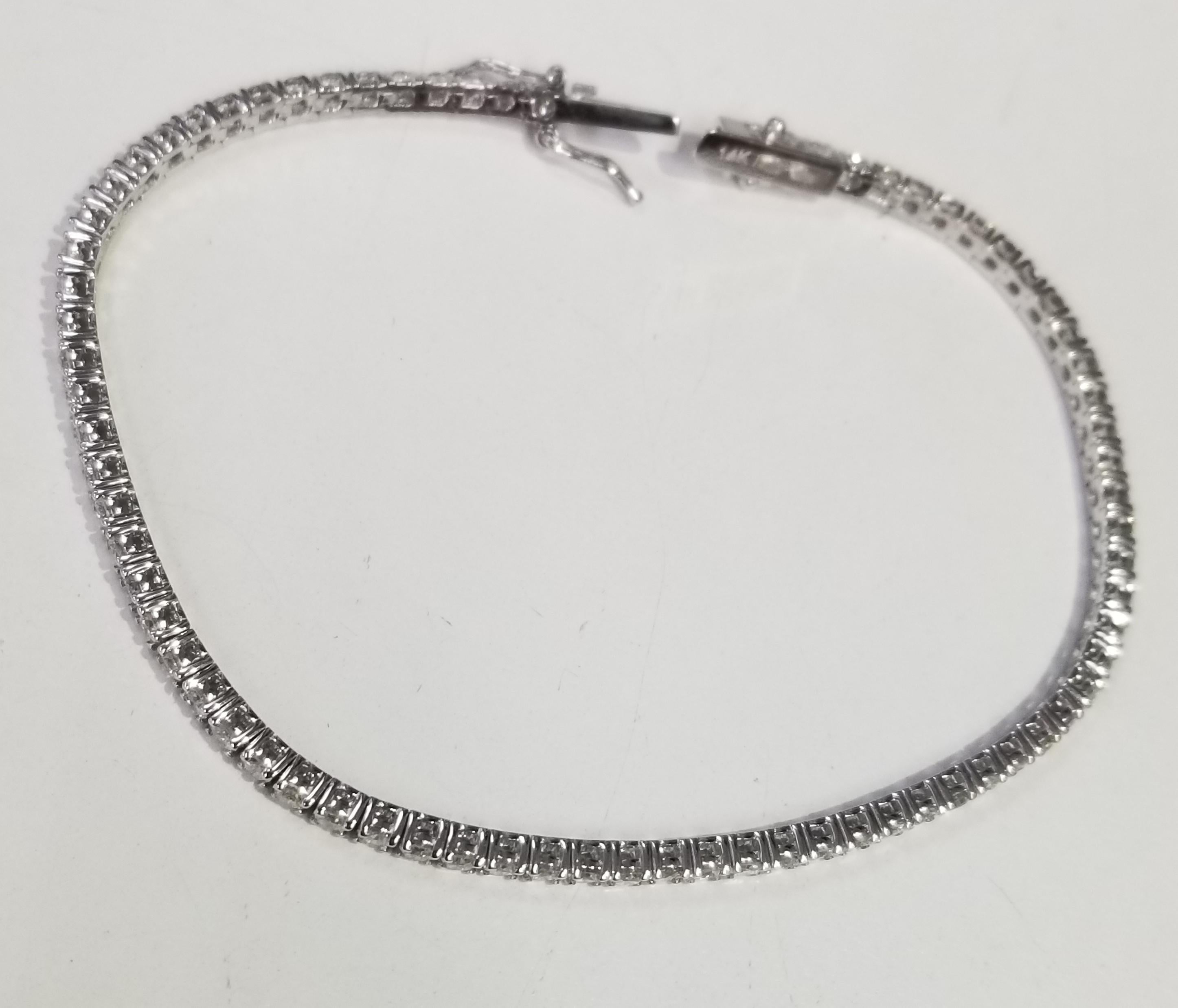 This is very beautiful 14k white gold custom made tennis bracelet with 75 round diamonds color F-G and clarity SI1 weighing 3.01cts. very fine quality diamonds, bracelet measures 7 inches with clasp and safety.
Specifications:
main stone: ROUND