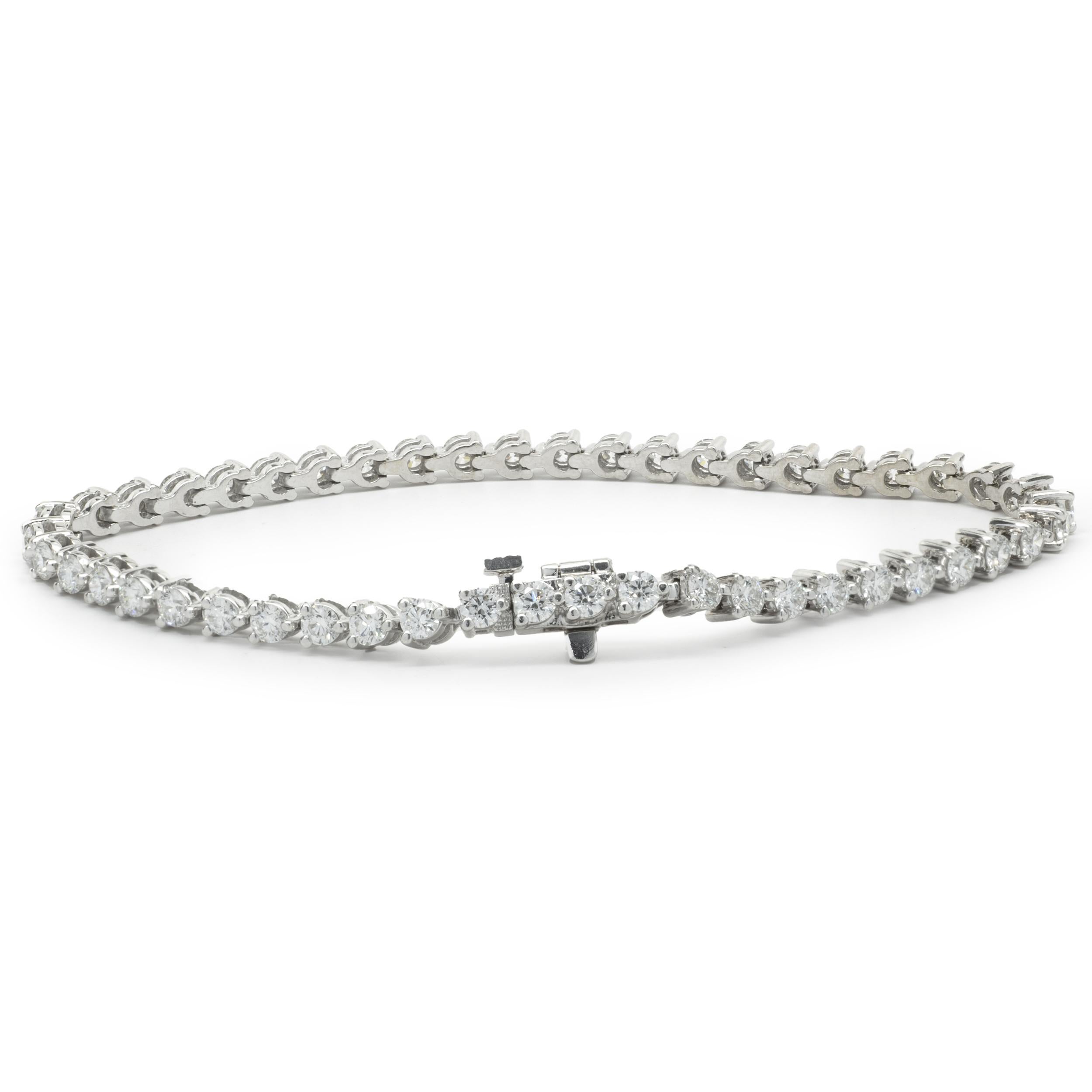 Designer: custom
Material: 14K white gold
Diamond: 48 round brilliant cut = 3.36cttw
Color: H
Clarity: VS2
Dimensions: bracelet will fit up to a 7-inch wrist
Weight: 10.15 grams
