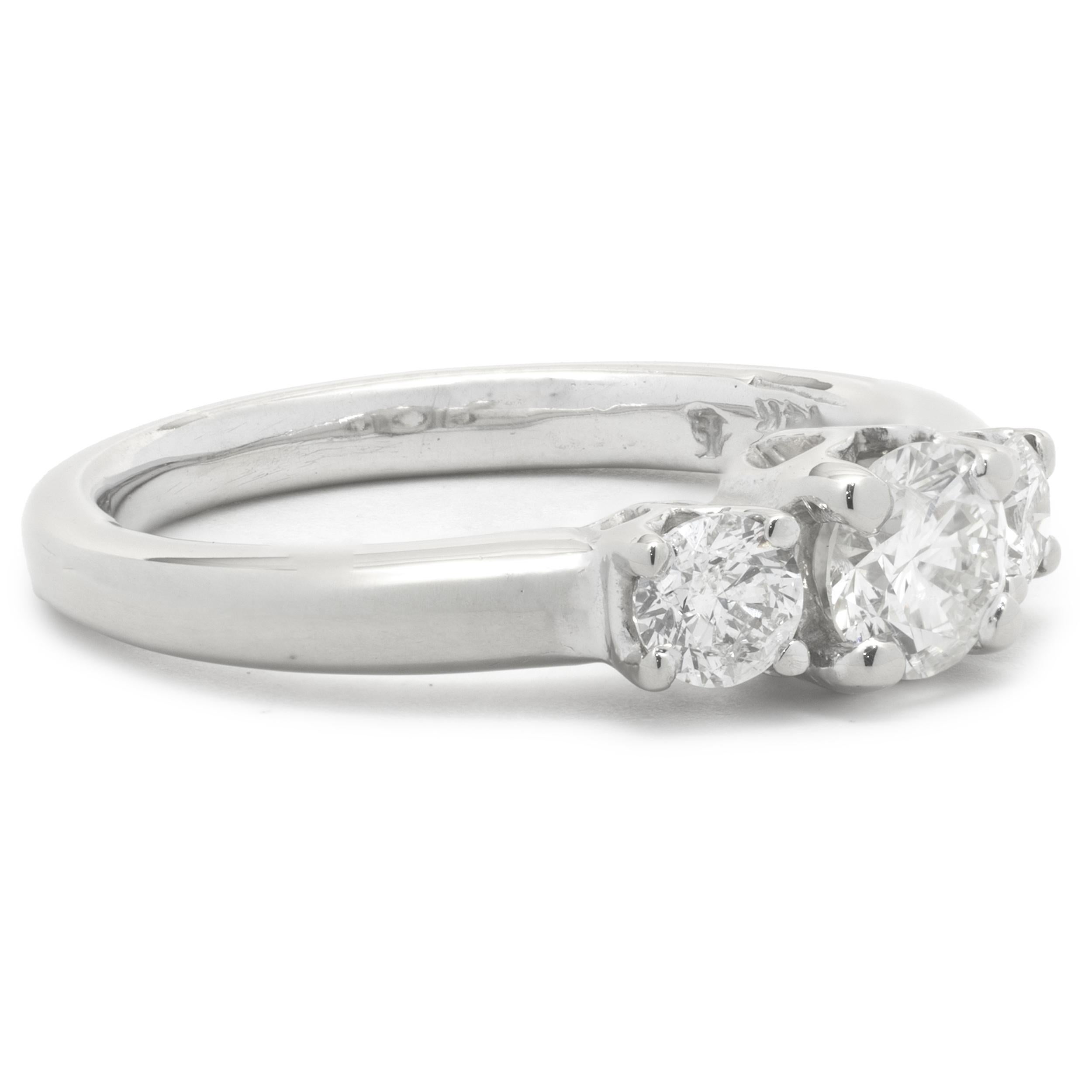 Designer: custom
Material: 14K white gold 
Diamond: 3 round brilliant cut = 0.40cttw
Color: H
Clarity: SI1
Ring Size: 5.25 (please allow up to 2 additional business days for sizing requests)
Dimensions: ring top measures 5mm wide
Weight: 3.27 grams
