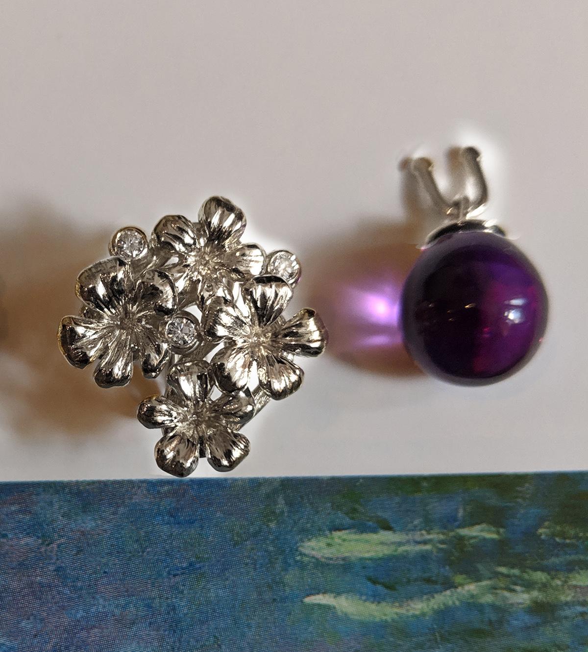 14 karat white gold Plum Blossom brooch with a removable amethyst drop, encrusted with 3 round diamonds, is a contemporary jewellery piece that has been featured in Vogue UA reviews. The cabochon gem can be easily replaced with other gem drops. We