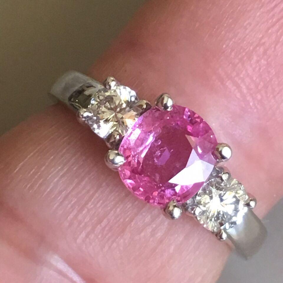 14k White Gold Pink Sapphire and Diamond engagement ring, finger size 7

7.1 mm by 6.2 mm by 3.3 mm, appx 1.12 Carat Natural Pink Sapphire(test pending), Two 3.9 mm Round Brilliant cut Diamonds appx 0.23 Carat each with TDW 0.46 Carat, clear and