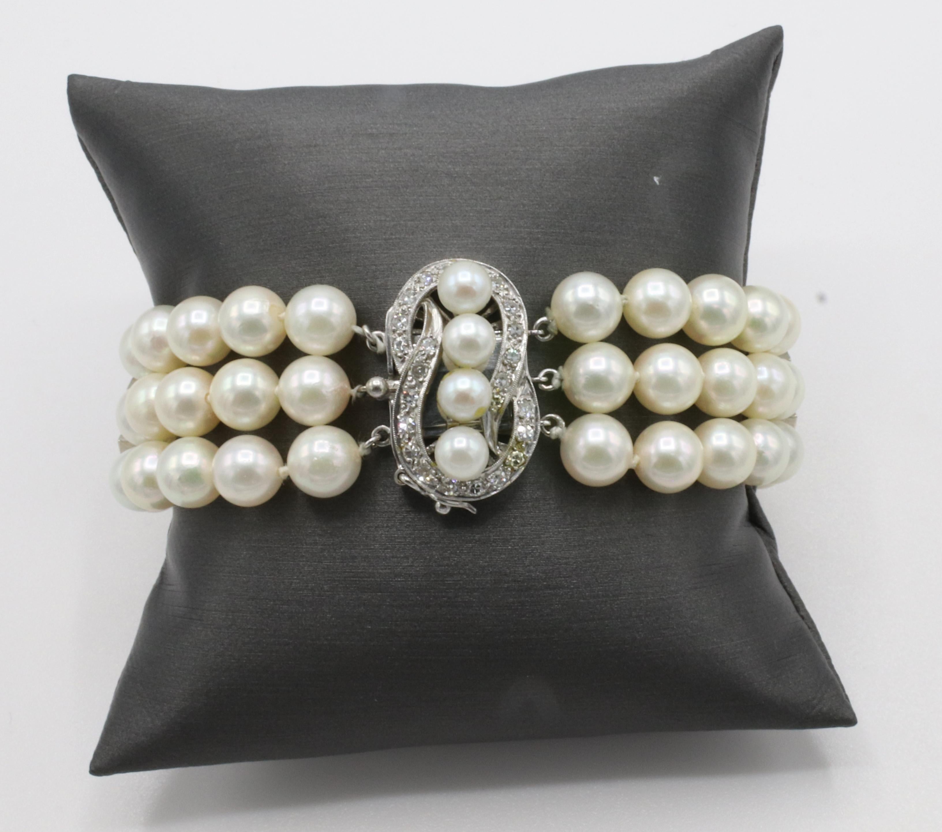 14 Karat White Gold Triple Strand Pearl & Diamond Bracelet 
Metal: 14k white gold
Weight: 43.8 grams
Pearls: 7mm (5mm on clasp), 3 strands 
Length: 7 inches
Width: 21mm
Diamonds: Approx. .28 CTW I SI single cut round diamonds

