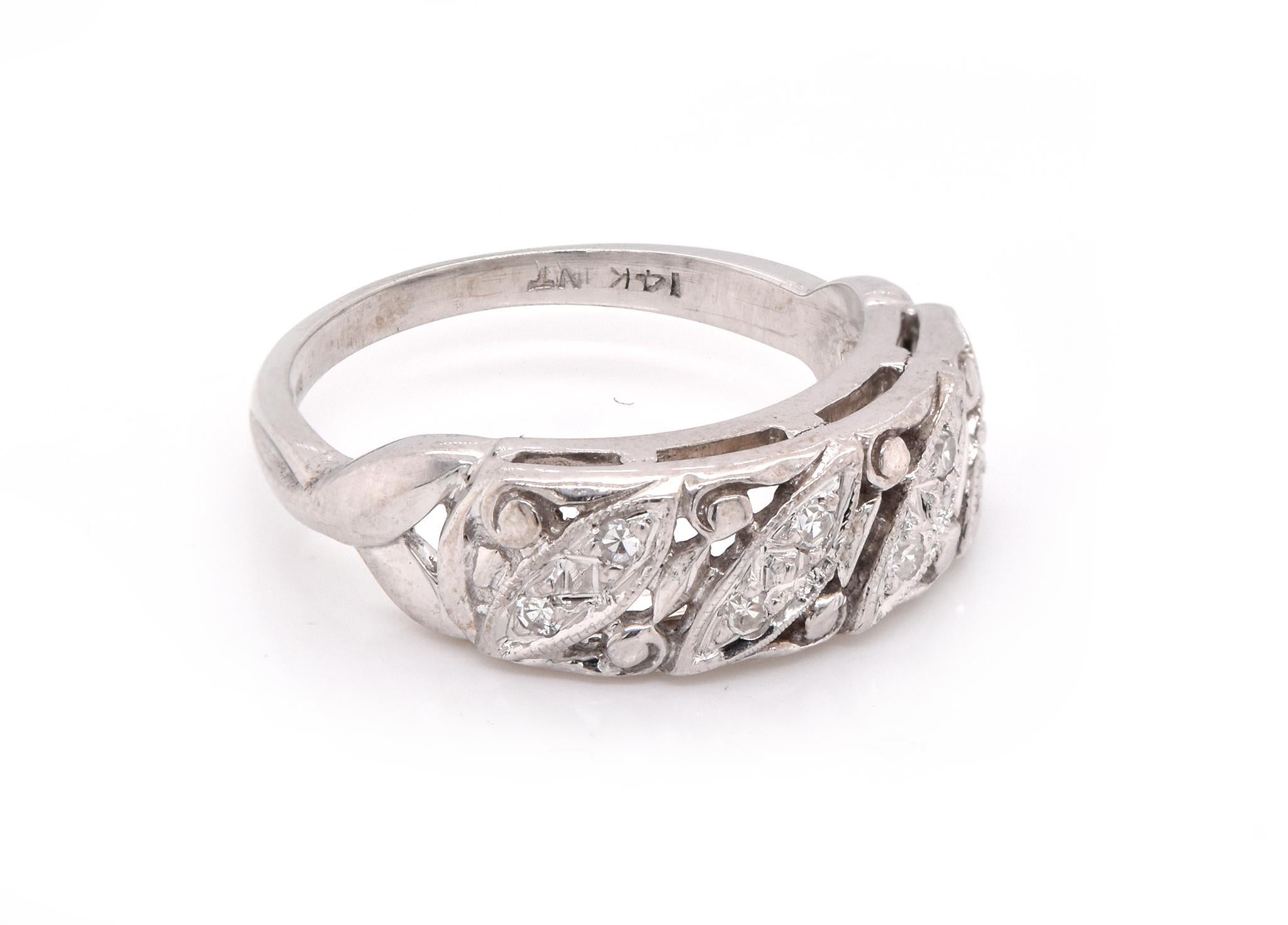 Designer: custom
Material: 14K white gold
Diamonds: 8 round cut = .10cttw
Color: H
Clarity: SI1
Ring size: 6 (please allow two additional shipping days for sizing requests)
Dimensions: ring top is 6.15mm wide 
Weight:  3.58 grams 
