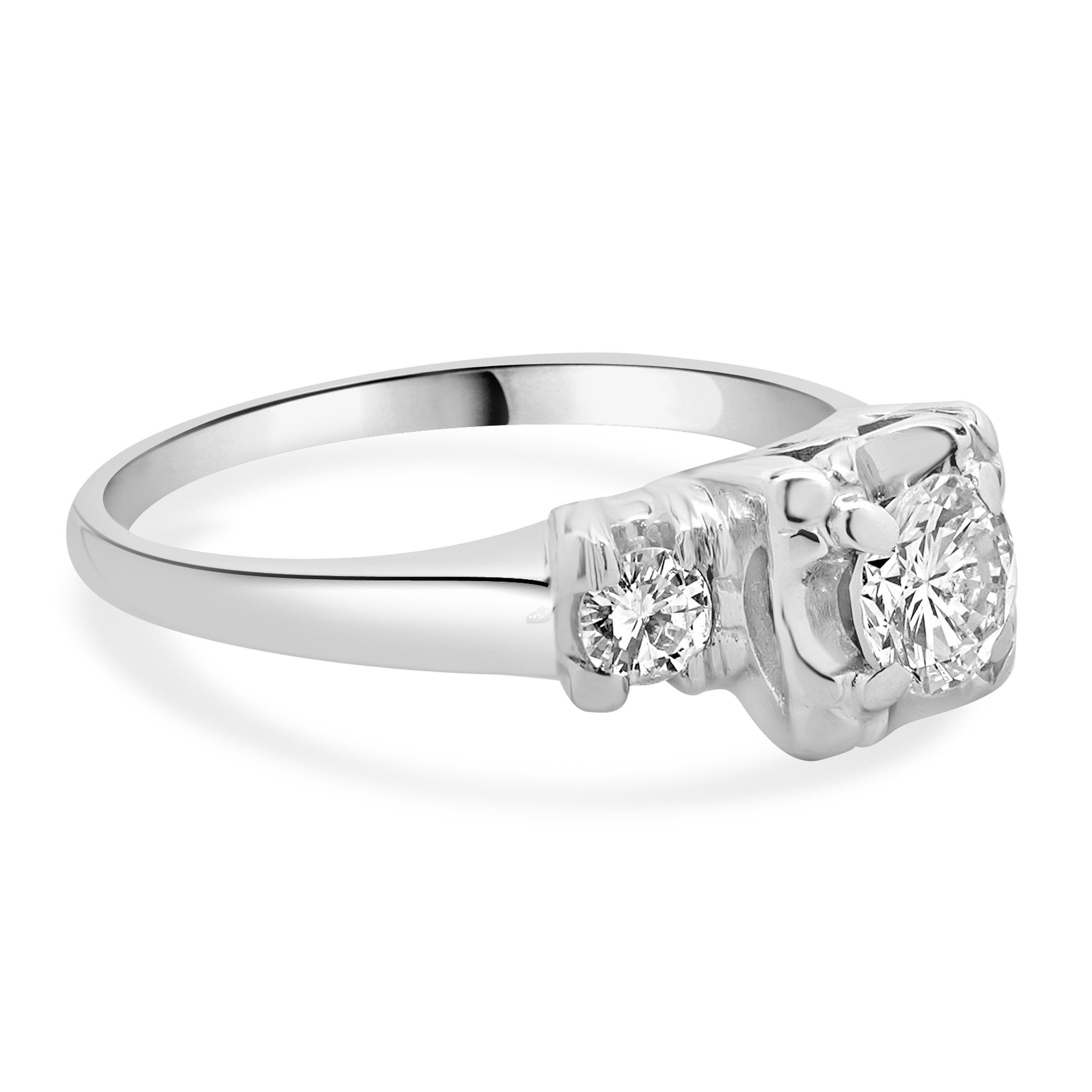 Designer: custom design
Material: 14K white gold
Center Diamond: 1 round brilliant cut = 0.45ct
Color : H
Clarity : I1
Diamond: 2 round brilliant cut = 0.24cttw
Color: H
Clarity: SI2
Dimensions: ring top measures 6.8mm
Size: 6.75 complimentary