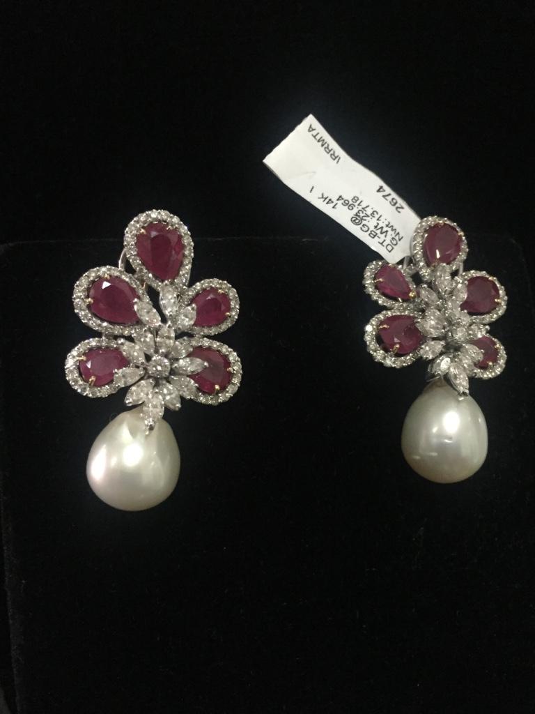 Diamond: 4.73 carats 
Ruby: 13.00 carats
Pearl: 33.50 carats 
Gold: 13.718 grams 14k 
Item Code: DT BG@
Colour: GH
Clarity: SI
Note: This piece is only available on order 

These Pearl Drop earrings studded with rubies and south sea pearls complete