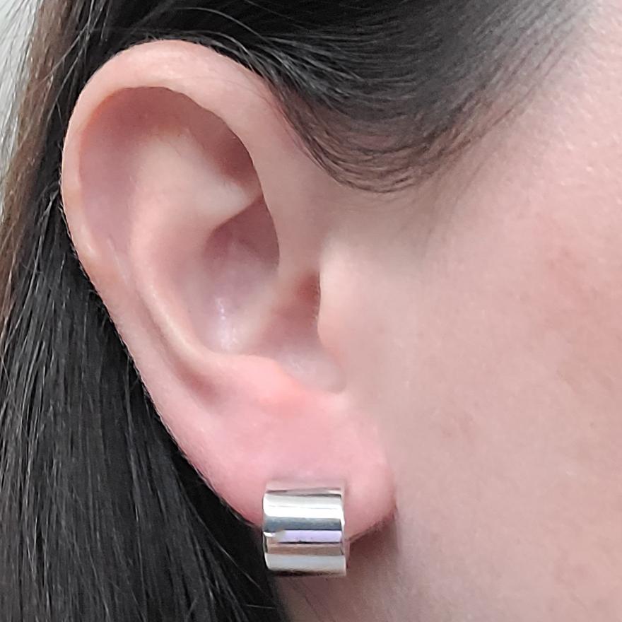 14 Karat White Gold 9mm Wide Huggie Hoop Polished Earrings. Pierced Post With Friction Back. Finished Weight Is 2.2 Grams.