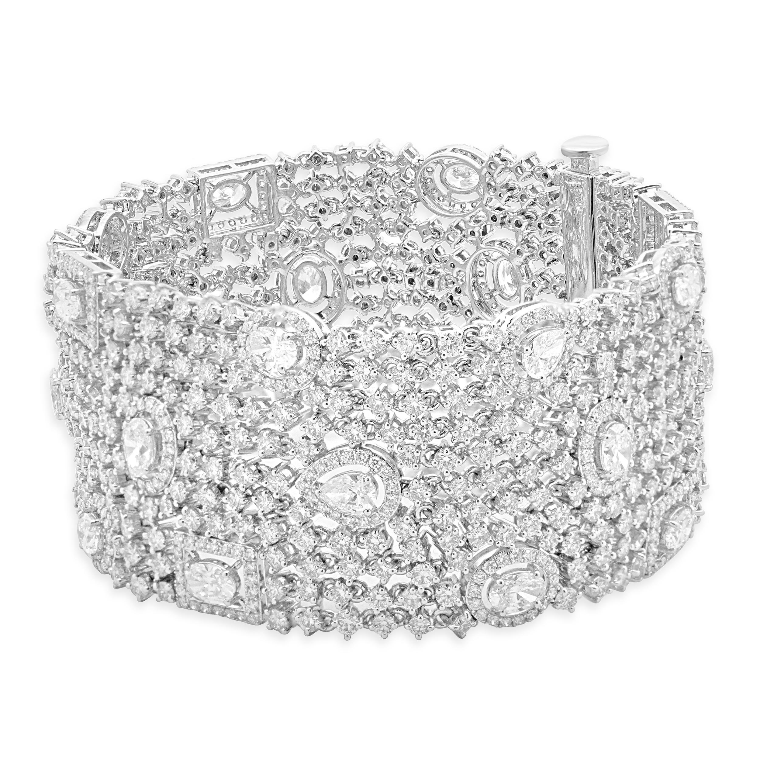 Designer: custom design
Material: 14K white gold
Diamond: round brilliant, oval, pear cut = 25.14cttw
Color: G / H
Clarity: VS2-SI1
Dimensions: bracelet will fit up to a 7-inch wrist
Weight: 60.72 grams

