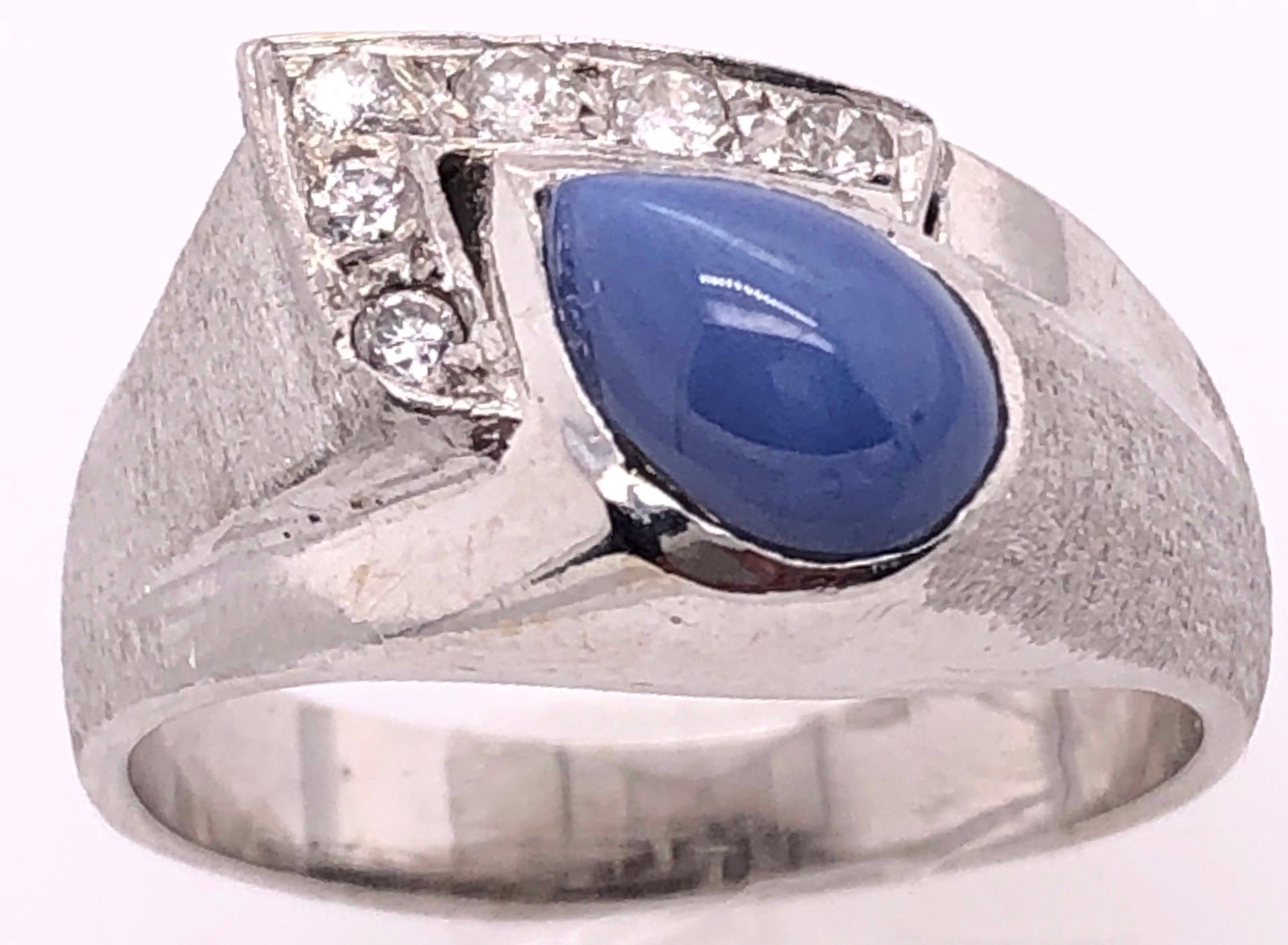 14 Karat White Gold With Teardrop Sapphire Cabochon Ring with Diamond Accents
0.25 Total Diamond Weight.
Size 9 
7.35 grams total weight.