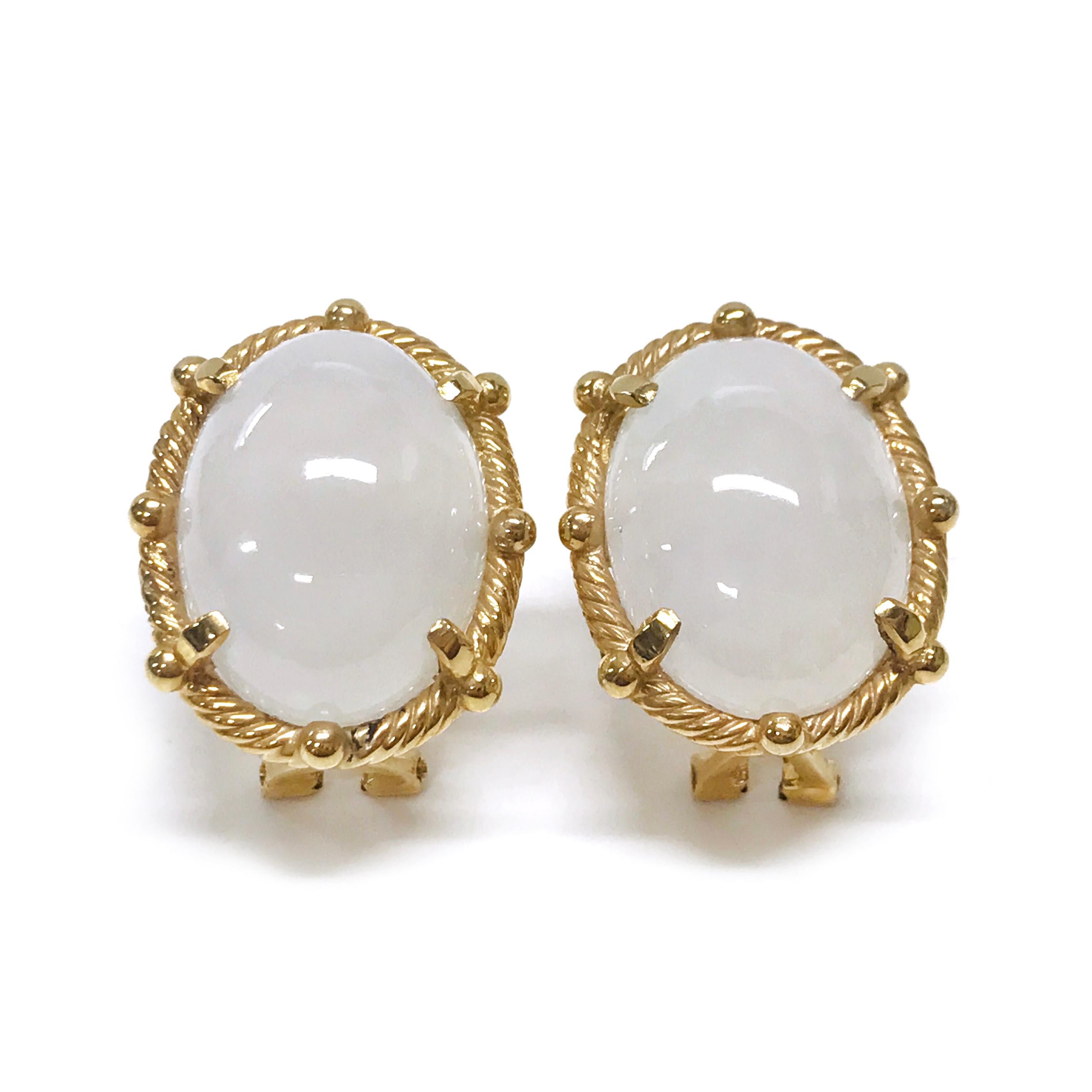 These White Jade Cabochon Stud Earrings are a perfect blend of elegance and craftsmanship. The earrings feature oval-shaped white jade cabochons, beautifully framed by a twisted gold rope bezel. Each stone is securely set in a four-prong setting,
