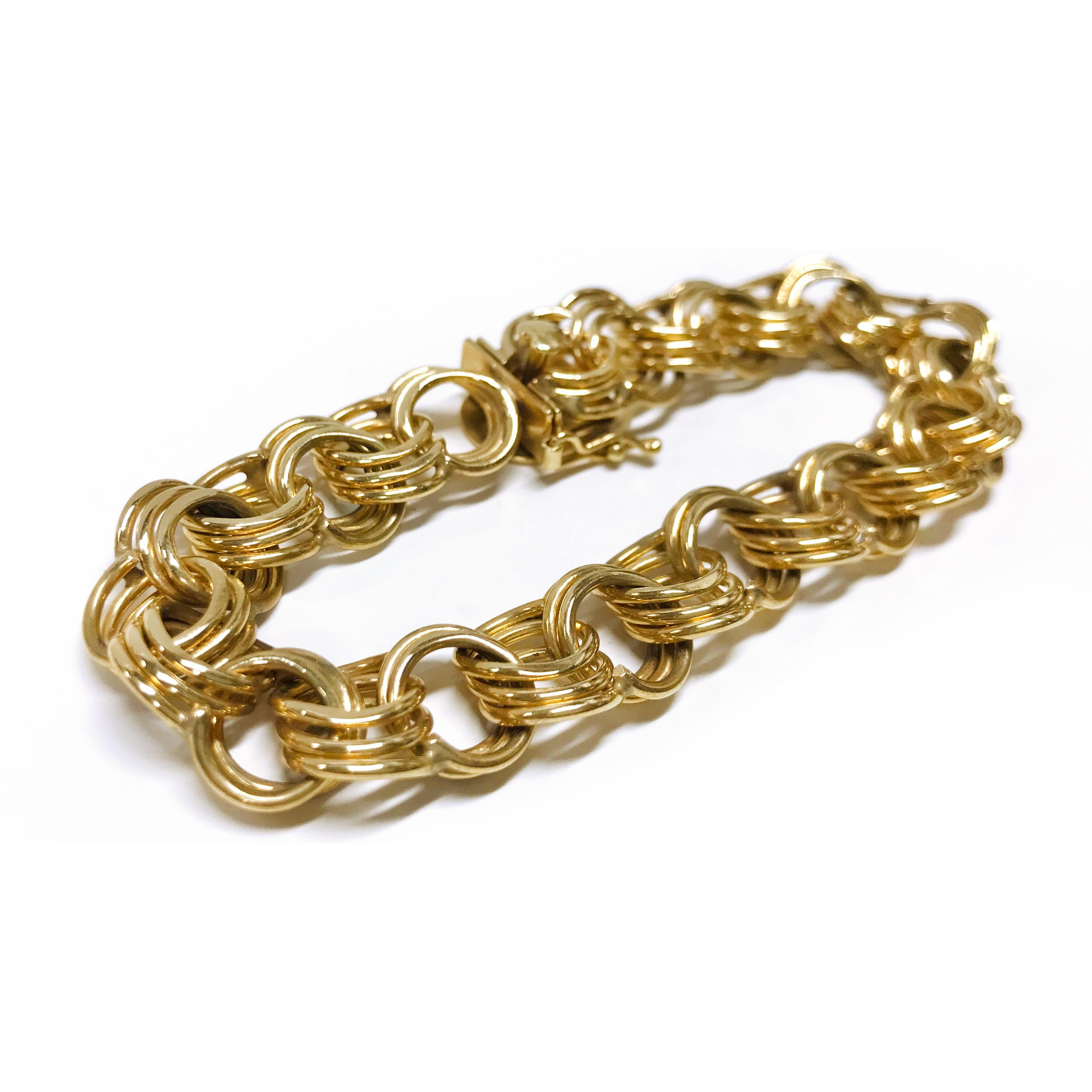 14 Karat Wide Triple Link Charm Bracelet. The bracelet features yellow gold triple links. The bracelet is 0.48
