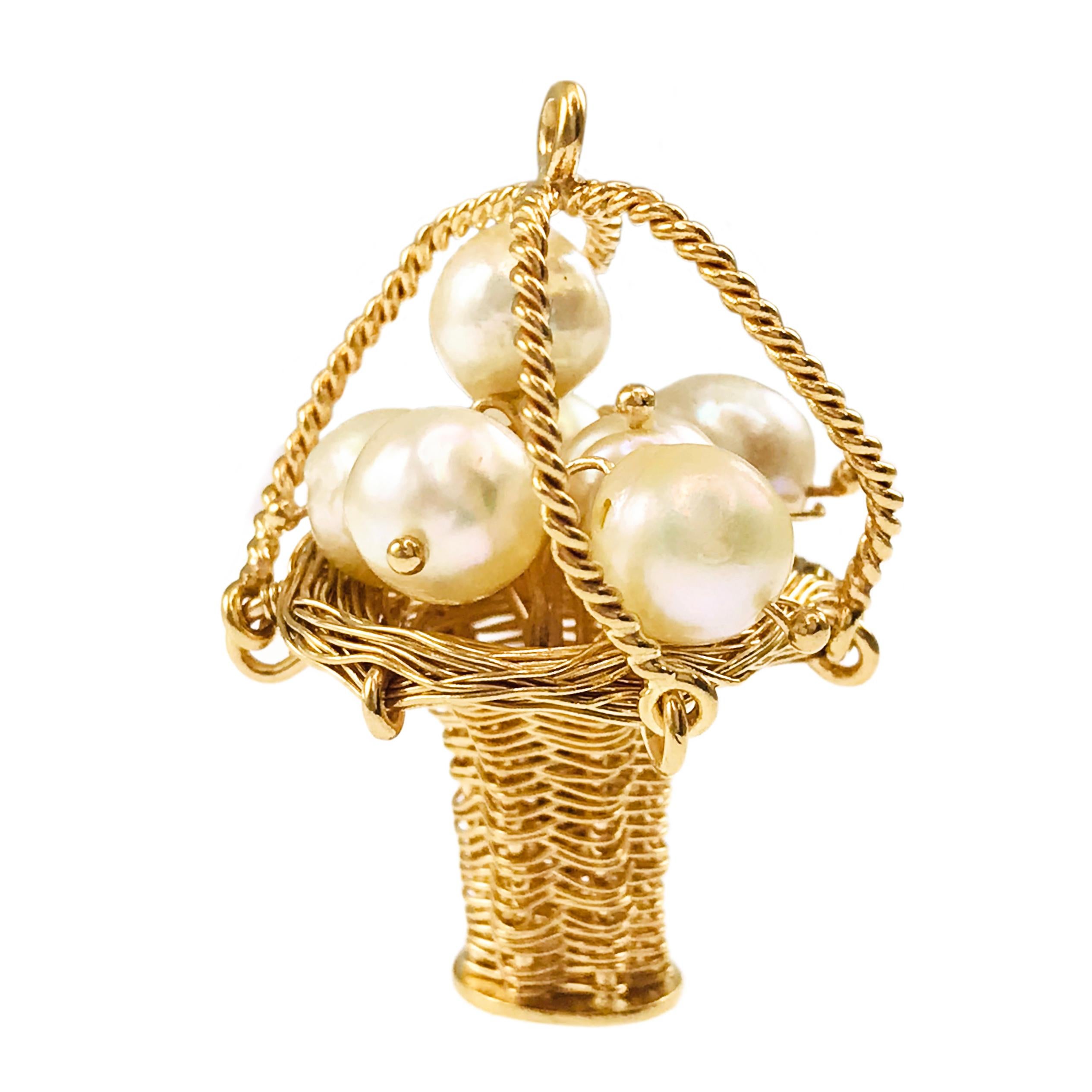 14 Karat Woven Wire Basket Cultured Pearls Pendant, circa the 1950s. Six cultured Pearls are featured atop this woven wire basket with four handles that meet and the top to form the bail. The pendant measures 24.23mm wide x 34.2mm tall. The total