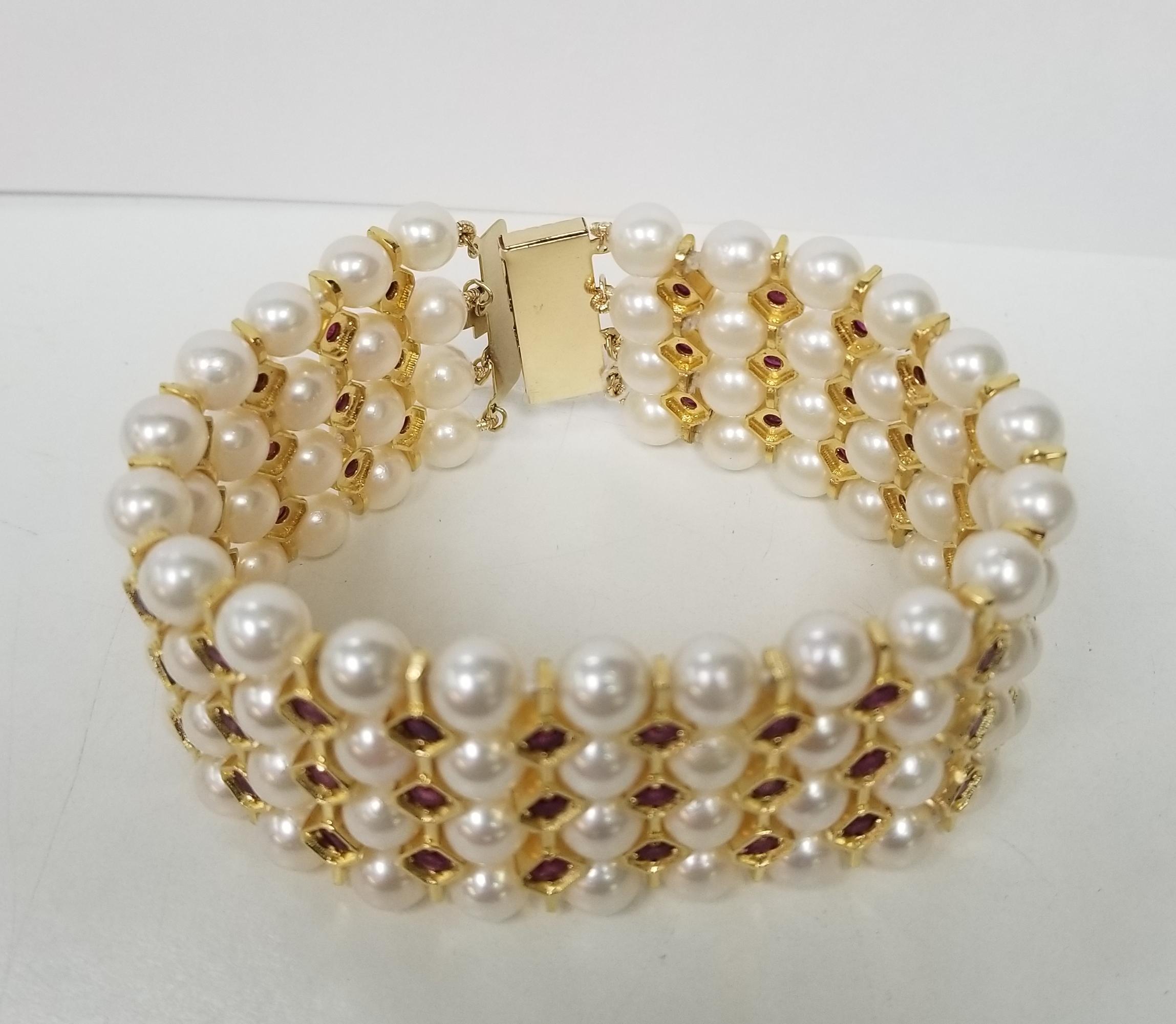 14 karat yellow and silver gold plated 4 row of cultured pearl and ruby bracelet.
Product Details
    Metal: 14K yellow gold and silver gold plated
    Measurements :
        Width: 33MM
        Thickness: 8.5mm
Specifications:
    main stone: ROUND