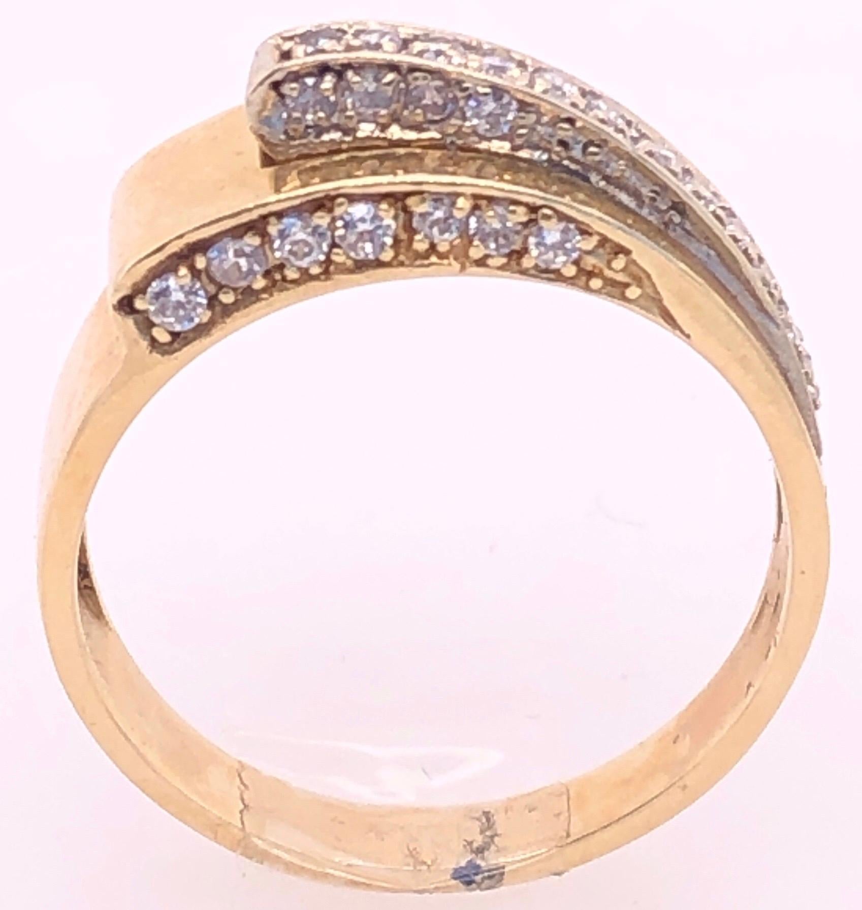 14 Karat Yellow and White Gold And Diamond Contemporary Ring Size 8.
40 round diamonds with 1.25 total  diamond weight.
4.78 grams total weight.