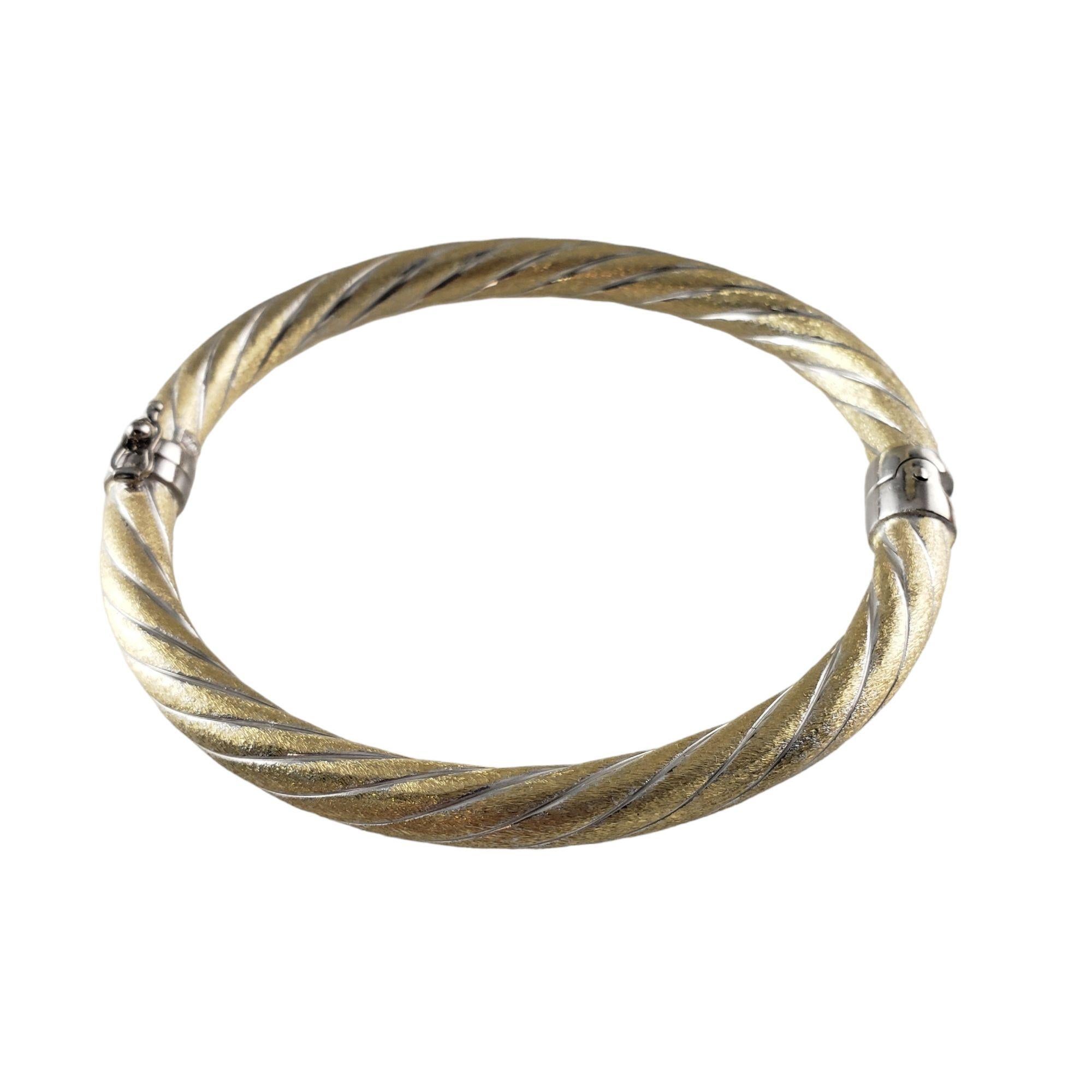 14 Karat Yellow Gold and White Bangle Bracelet

This elegant hinged bangle bracelet is crafted in meticulously detailed 14K yellow and white gold.  

Width:  6 mm.

Size:  7 inches

Weight:  10.8 gr./  6.9 dwt.

Stamped:  14K

Very good condition,