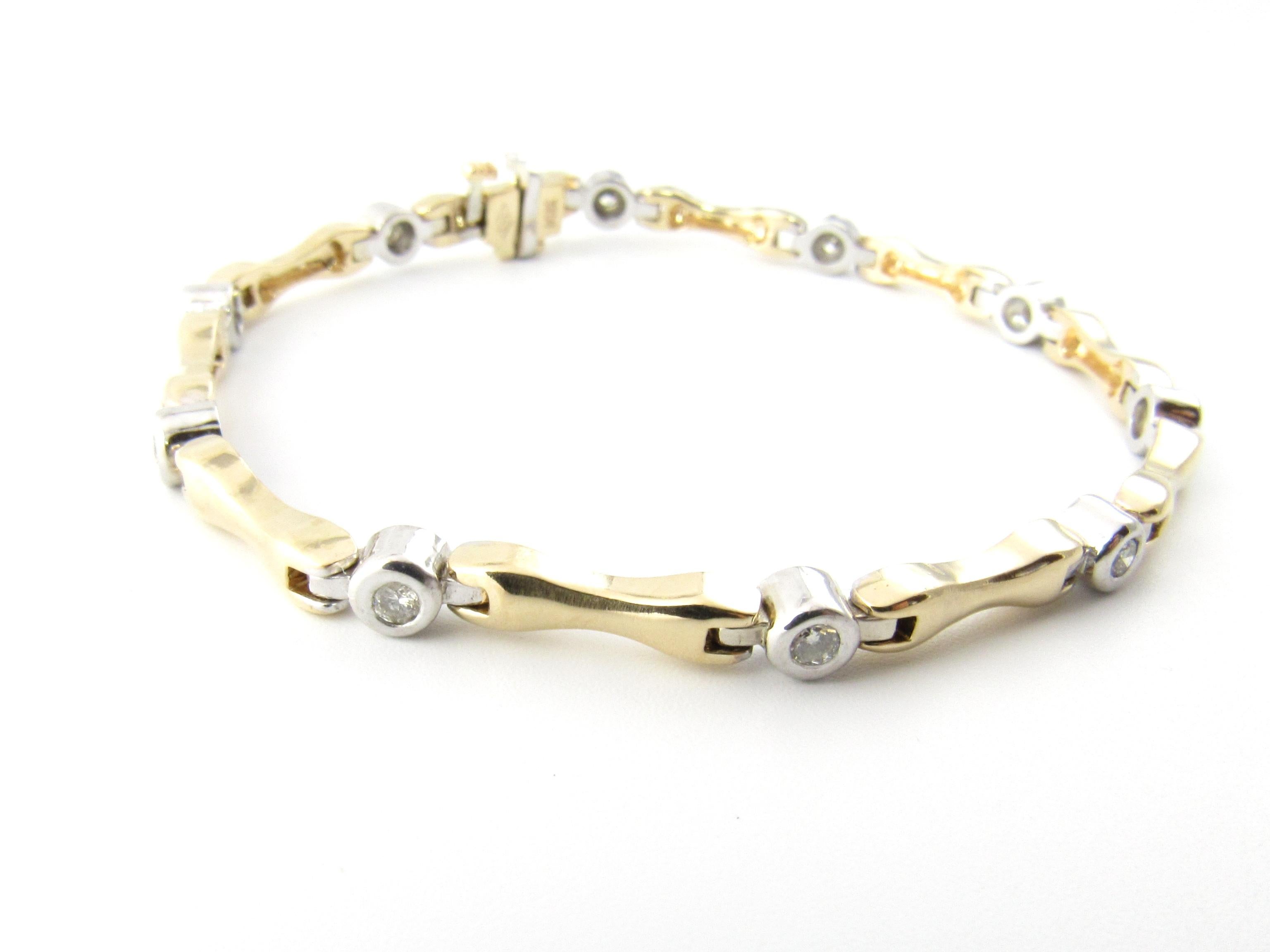 Vintage 14 Karat Yellow and White Gold and Diamond Bracelet

This sparkling bracelet features ten round brilliant cut diamonds set in beautifully detailed 14K white gold with yellow gold links

Width: 4 mm.

Approximate total diamond weight: .50