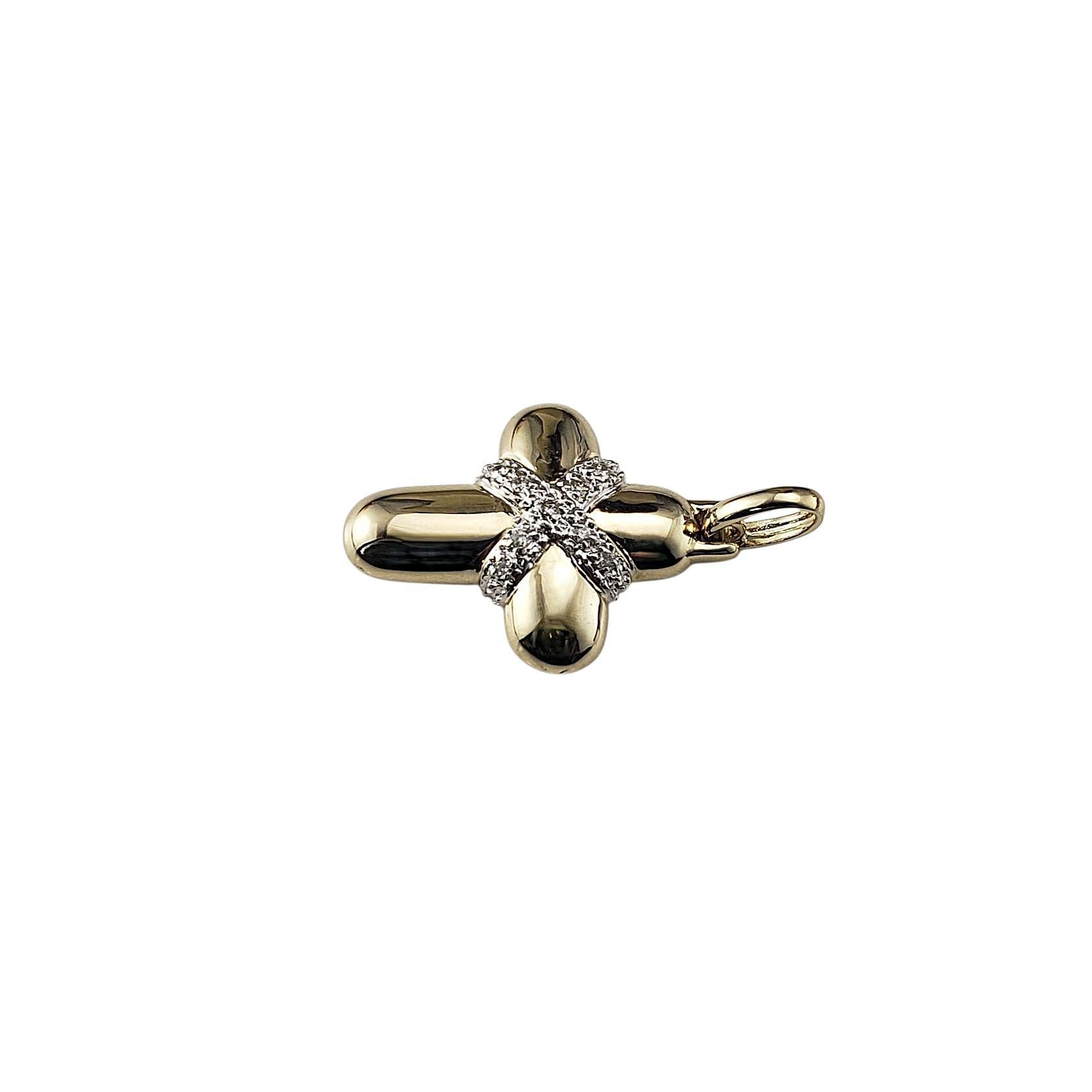 14 Karat Yellow and White Gold and Diamond Cross Pendant-

This elegant yellow gold cross pendant features 10 round brilliant cut diamonds at its center set in polished 14K white gold, blending faith with refined style.

Approximate total diamond