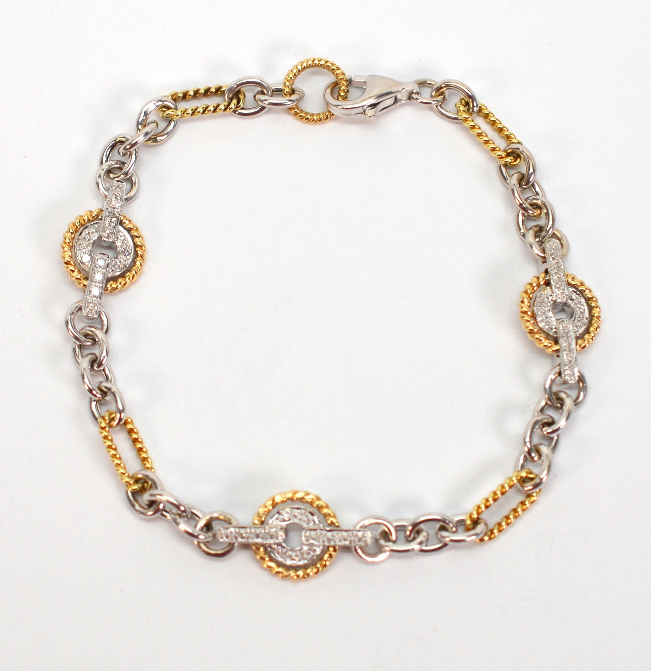Feminine and versatile this bright bracelet boasts both cable and paper clip style chain with mixed metals in both 14 karat white gold and 14 karat yellow gold. Along the seven inch length are three distinct circular diamond stations with 42 round