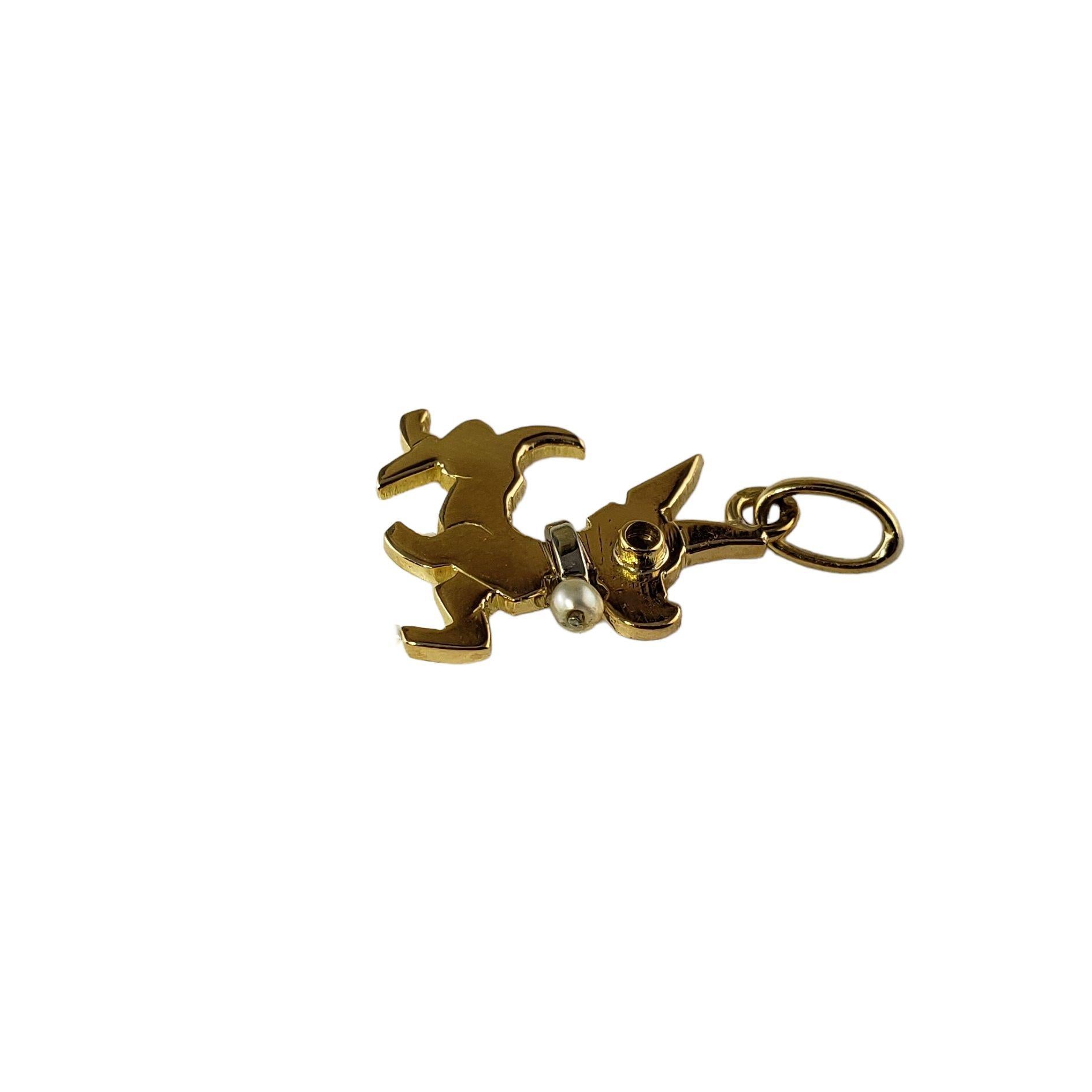This adorable dog charm features one seed pearl and one red gemstone set in beautifully detailed 14K yellow and white gold.

Size:  15 mm x 12 mm

Weight:  1.2 gr./  0.7 dwt.

Tested 14K gold.

Very good condition, professionally polished.

Will