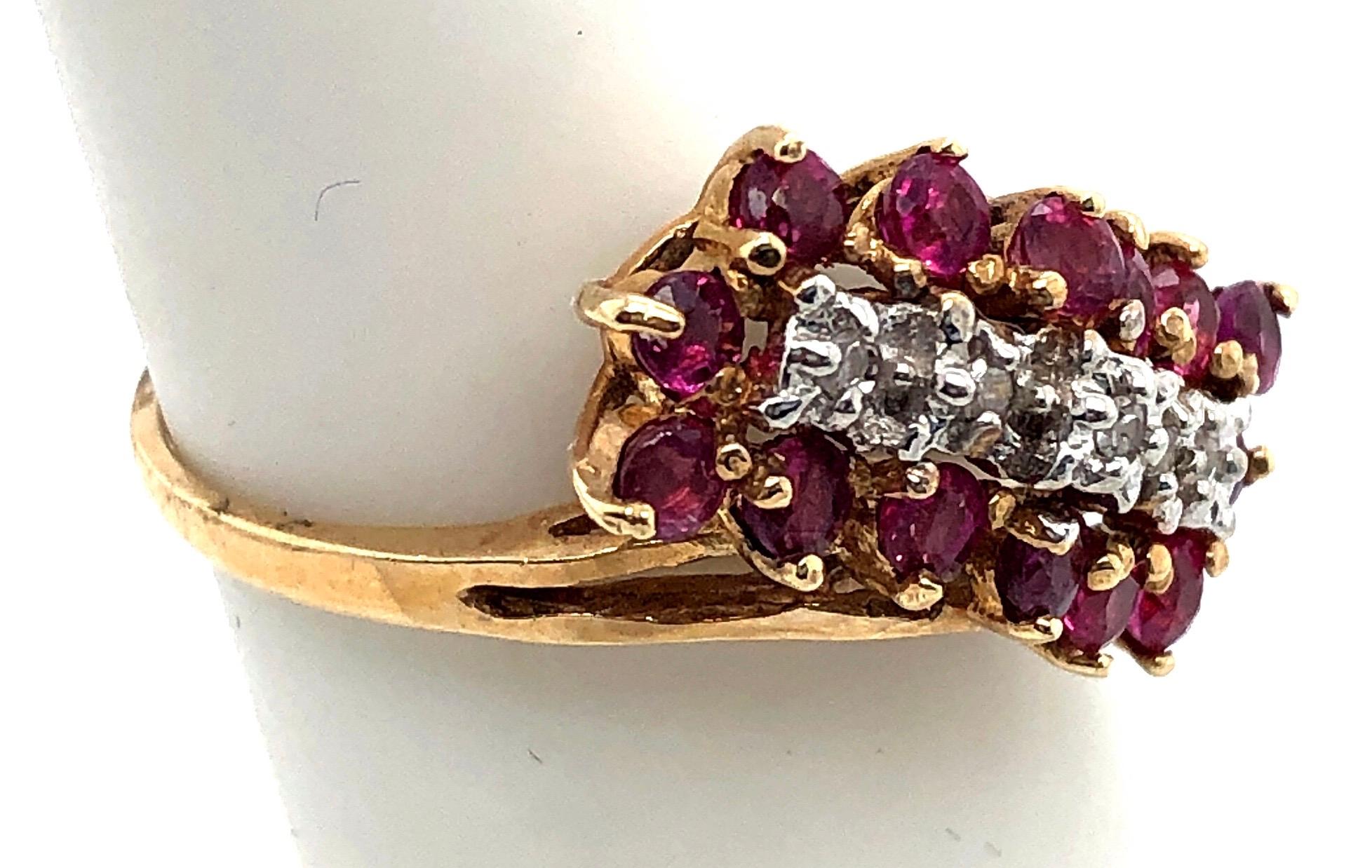 14 Karat Yellow Gold Ruby and Diamond Cluster Ring Size 5
The diamonds are set on white gold.
0.25 total diamond weight.
14 piece round rubies
3.13 grams total weight.
