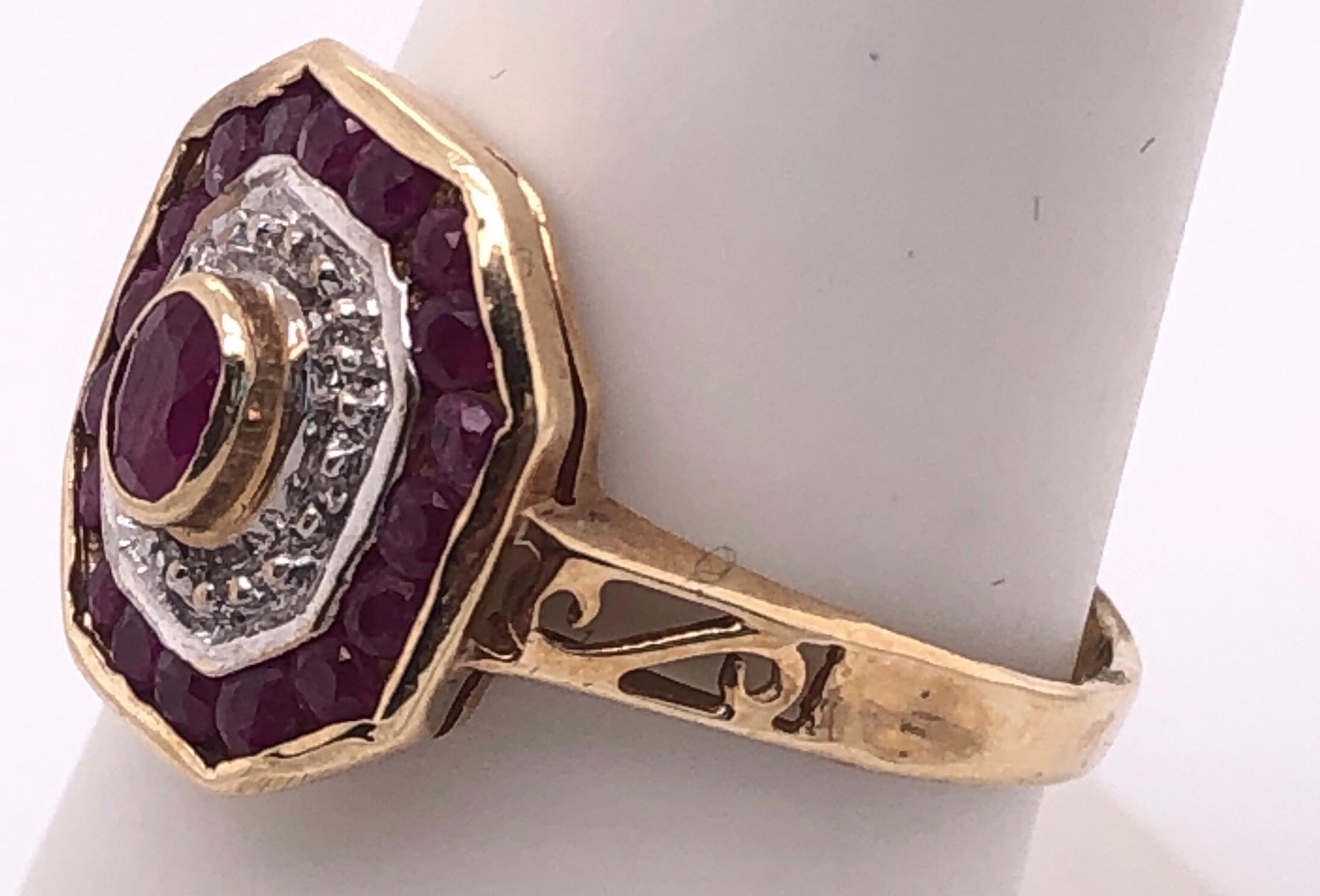 14 Karat Yellow and White Gold Ruby and Diamond Ring With Side Scroll
Size 6.25
