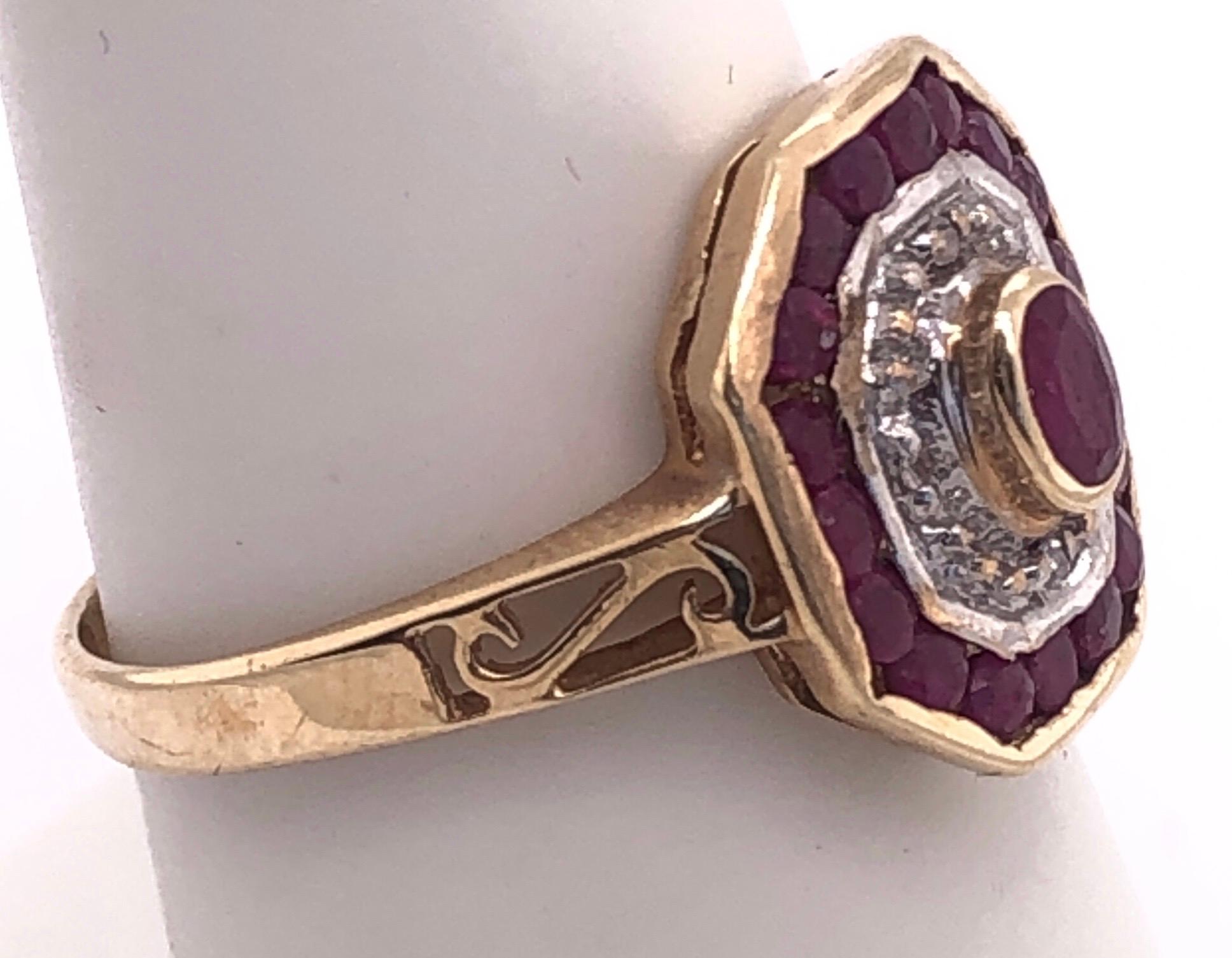 14 Karat Yellow and White Gold Ruby and Diamond Ring with Side Scroll In Good Condition In Stamford, CT