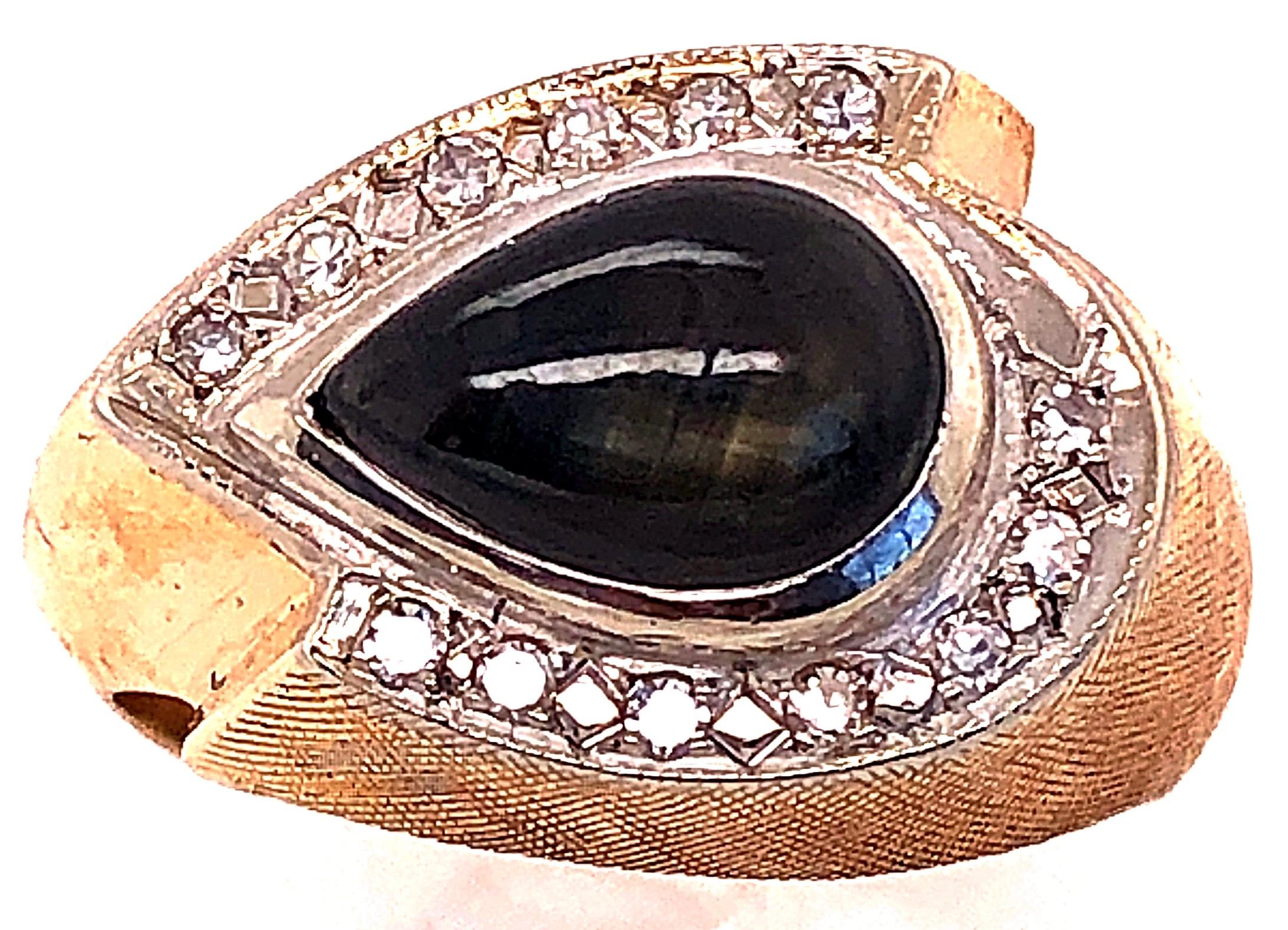 14 Karat Yellow and White Gold Sapphire Ring With Diamond Accents
0.26 total diamond weight.
6.92 mm x 9.80 mm dark blue sapphire 
Size 7
7.67 grams total weight.
13.79 ring height.
