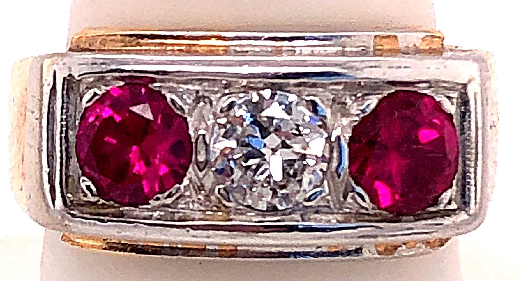 14 Karat Yellow and White Gold Three Stone Diamond and Ruby Band Ring
0.65 total diamond weight.
Size 8
8.90 grams total weight.
9.74 ring height.