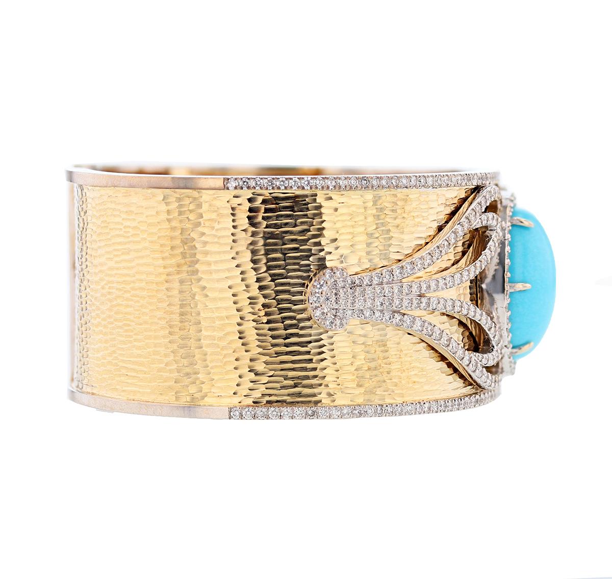 This bangle is made in 14K yellow and white gold and features an oval cut, prong set Turquoise measuring 20x15mm. The bangle also features 256 round cut pave set diamonds weighing 4.13cts with a color grade (H) and clarity grade (SI2). 