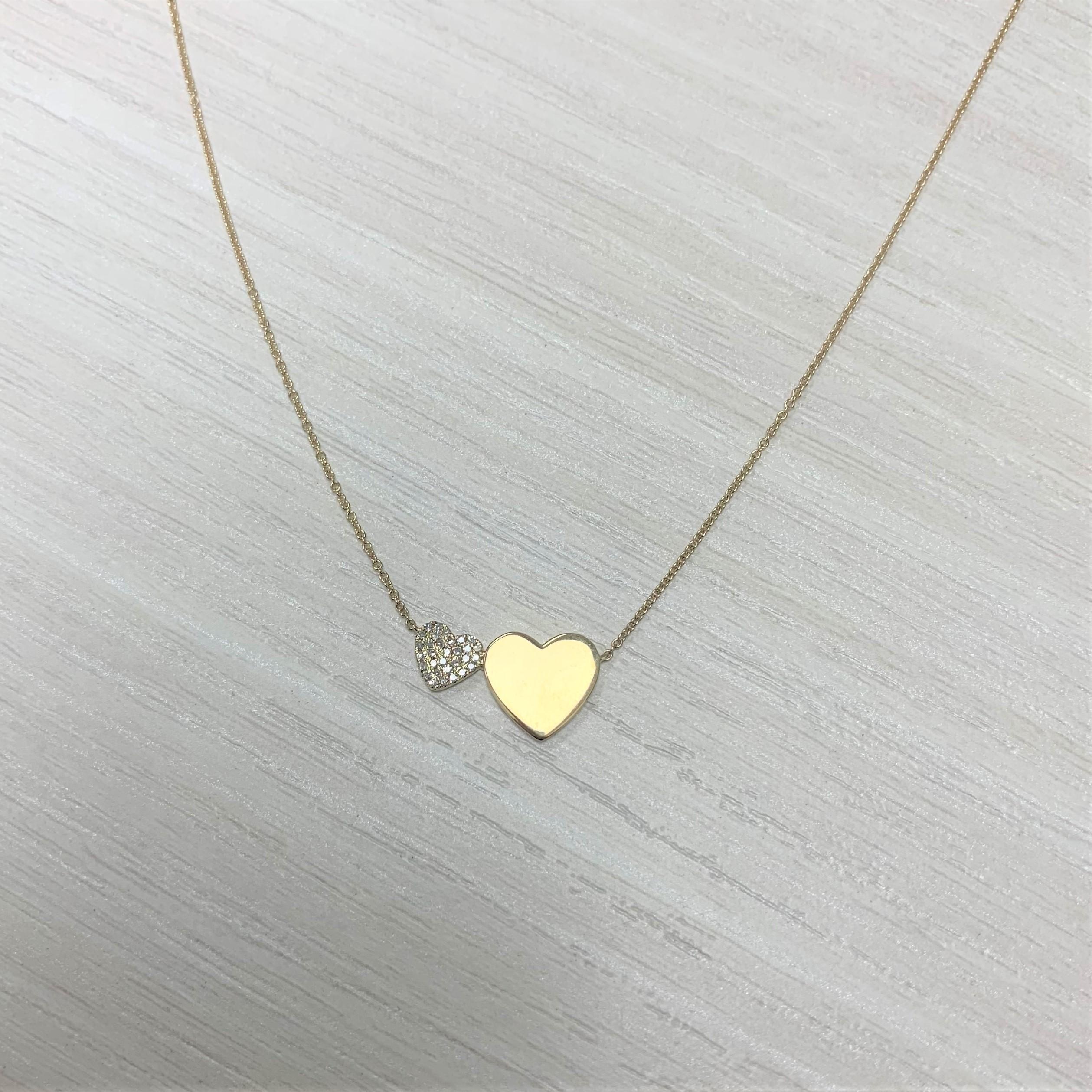 The brilliance of love. This diamond necklace features 0.09 ct of round sparkly diamonds, pavé-set in a heart shape made of 14k yellow gold, with a matching cable chain necklace.  
-14K Gold
-Diamond Weight: 0.09 carats Natural White