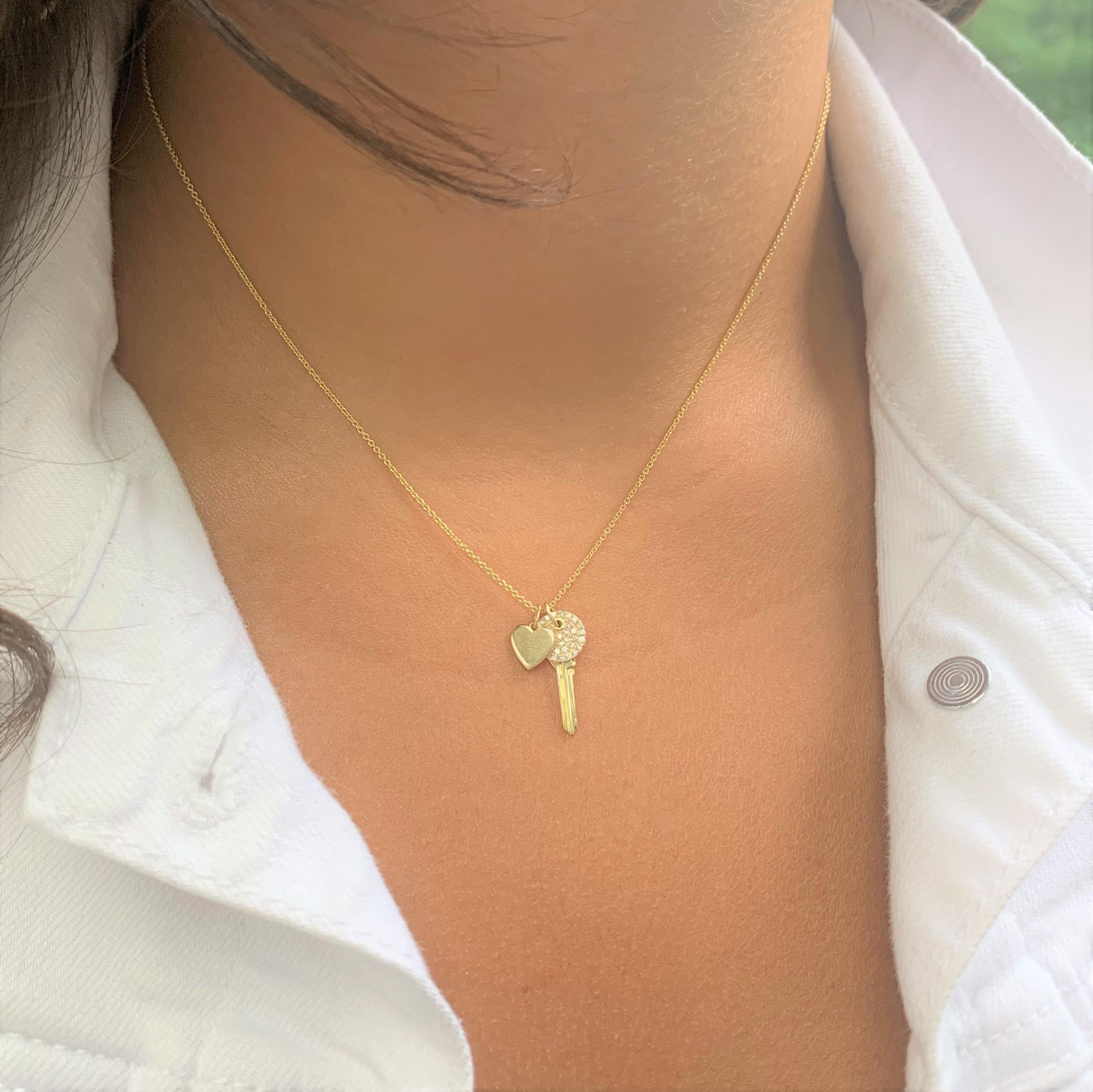 Unlock the Key to your Heart or the Heart of a Loved one :) This Beautiful Pendant is crafted of 14K Yellow Gold and features 0.14 ct. of round white diamonds on an adjustable 16