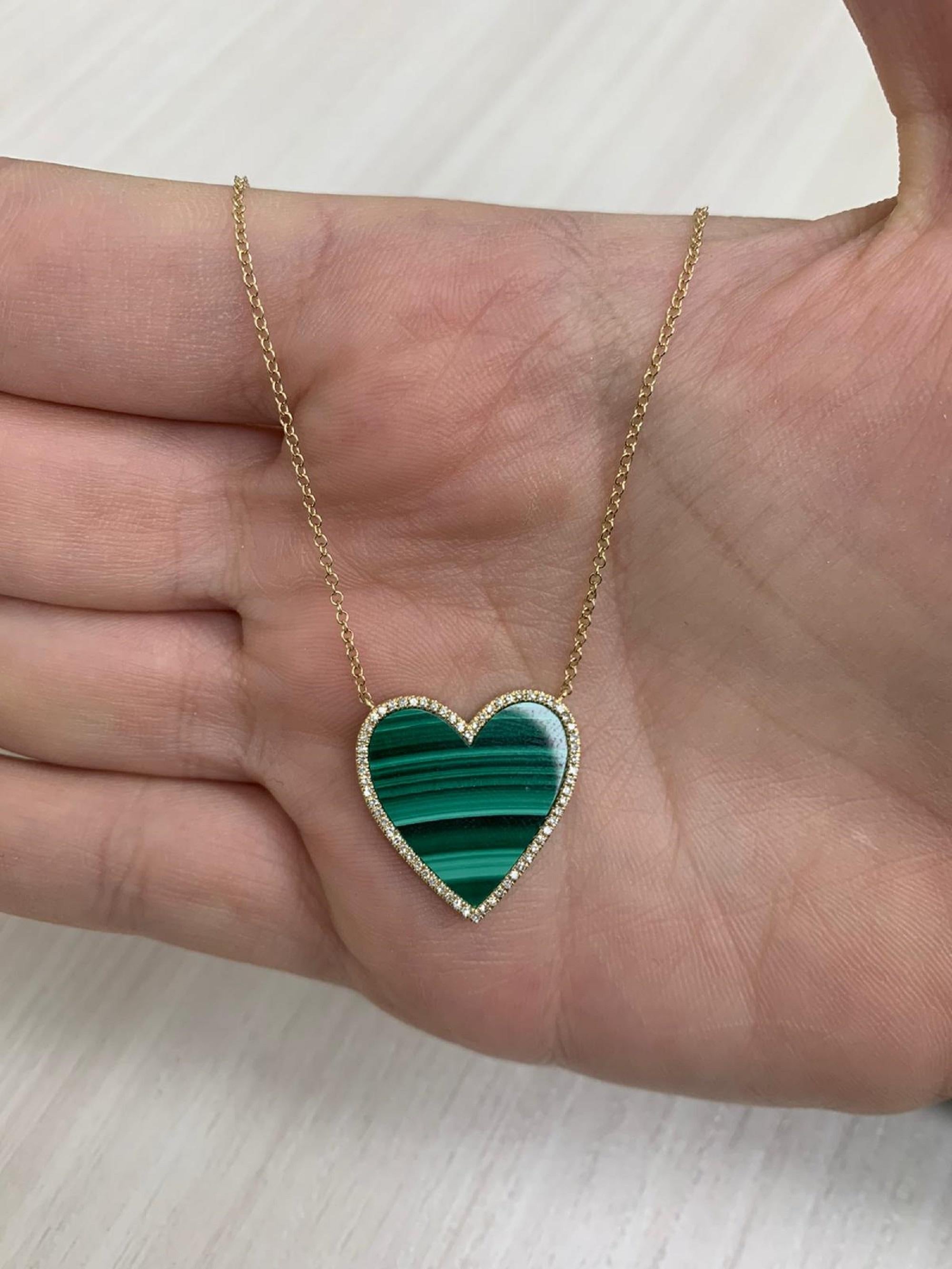 This is a Beautiful & Unique Heart Necklace crafted of 14K Yellow Gold and features 1 Heart Shaped Malachite 4.46 carats and is surrounded by 0.15 carats of Natural Round White Diamonds hangs on an 16