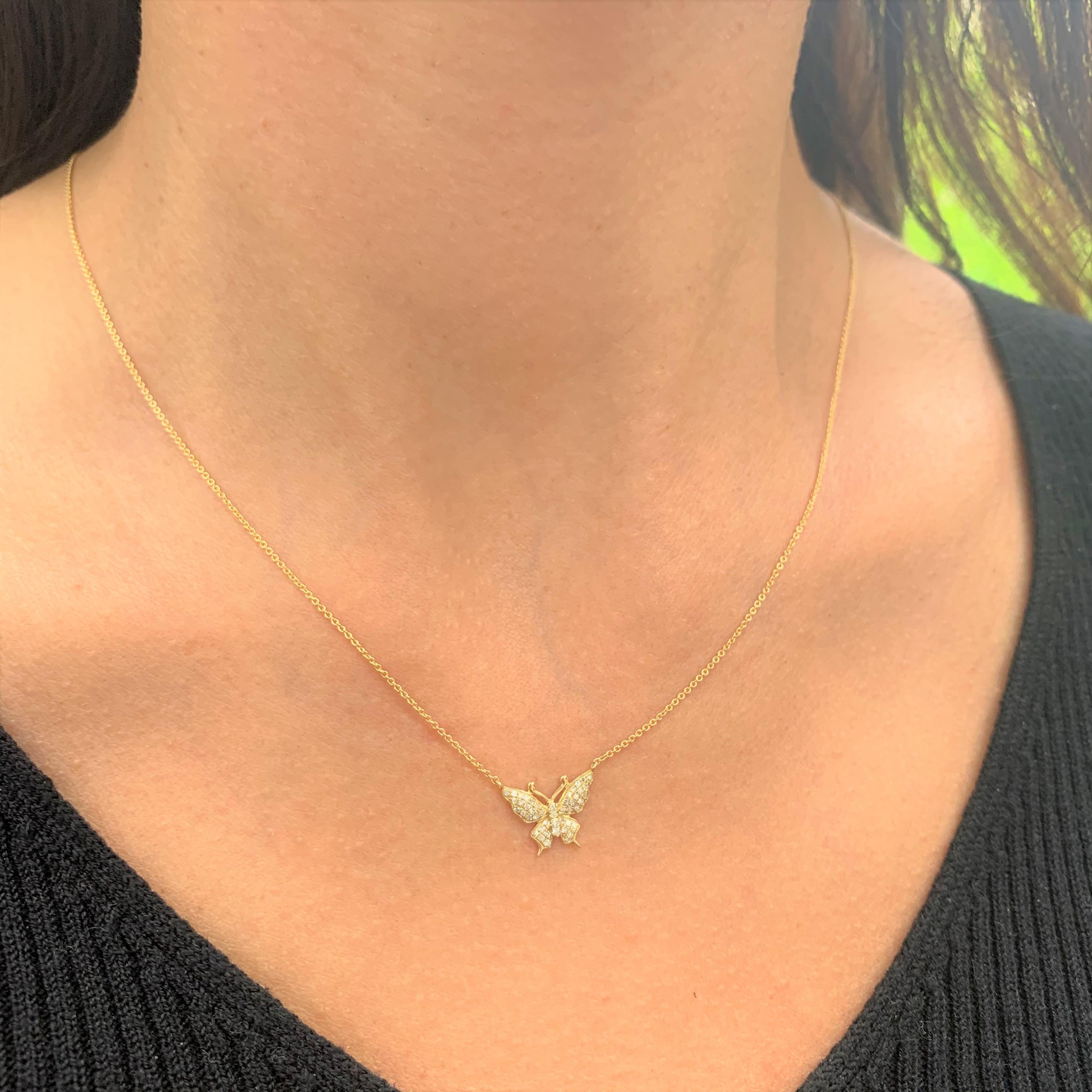 Fluttery diamond wings create an almost magical sparkle on this whimsical butterfly pendant necklace. This diamond necklace features 0.16 ct of round diamonds, pavé-set in a heart shape made of 14k yellow gold, with a matching cable chain necklace. 