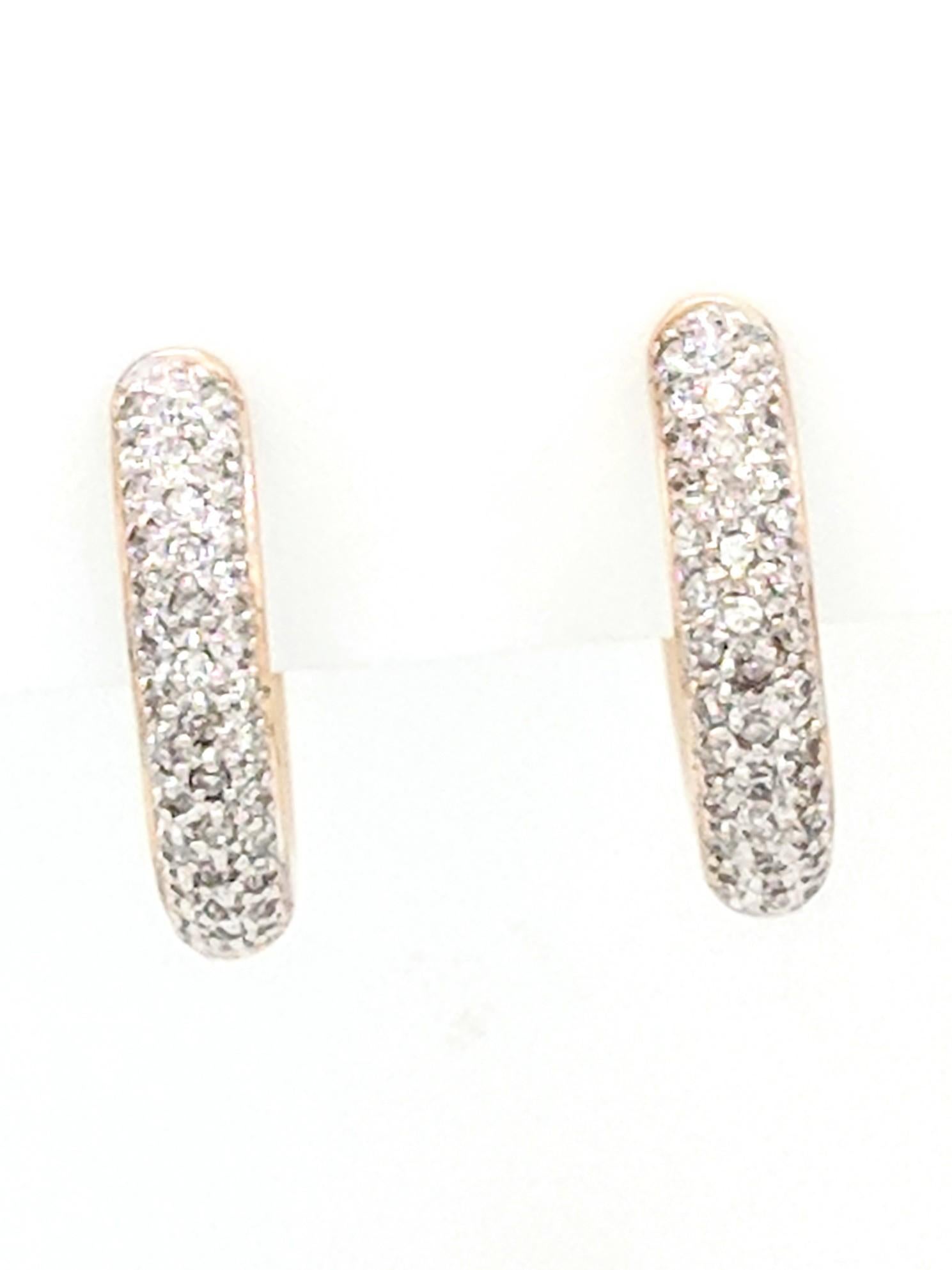 You are viewing a beautiful pair of ladies pave diamond huggie hoop earrings. These earrings are crafted from 14k yellow gold and weigh 7.6 grams. They measures 20mm in diameter and 4mm in width. Each earring features natural round brilliant cut