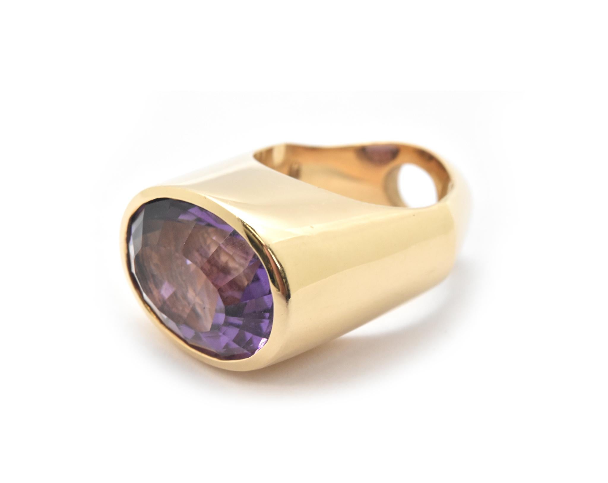 This ring is made in 14k yellow gold and set with a mixed oval cut 10ct amethyst by designer Gauthier. The band on this ring is beveled at each side of the shank. Band size is 4.75 and total weight of the ring is 22.81 grams.