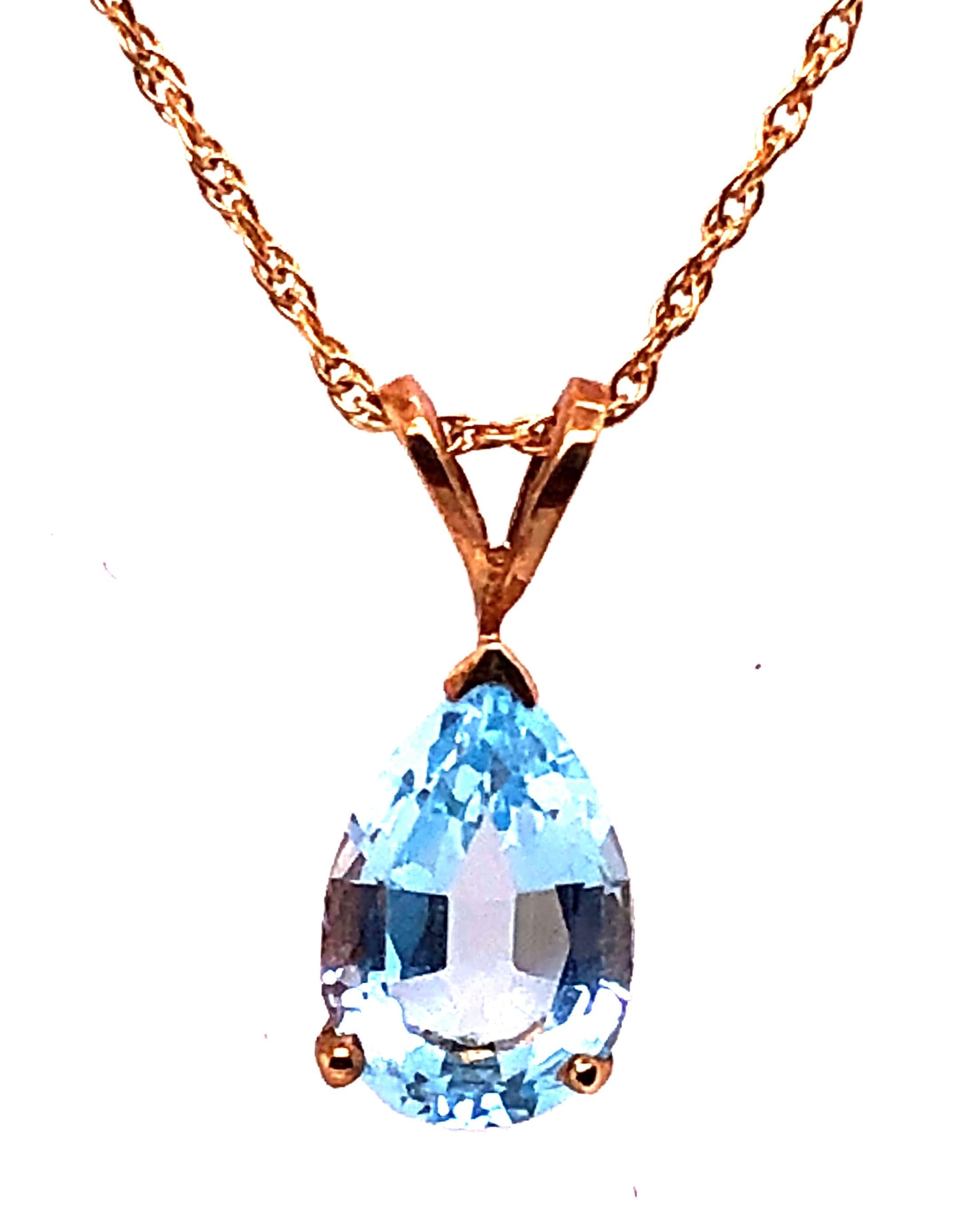 14 Karat Yellow Gold 16 Inch Free Form Necklace with One Pear Blue Topaz Pendant. Pendant is 11 by 6.63mm. 2.2 grams total weight. Stamped 14K
