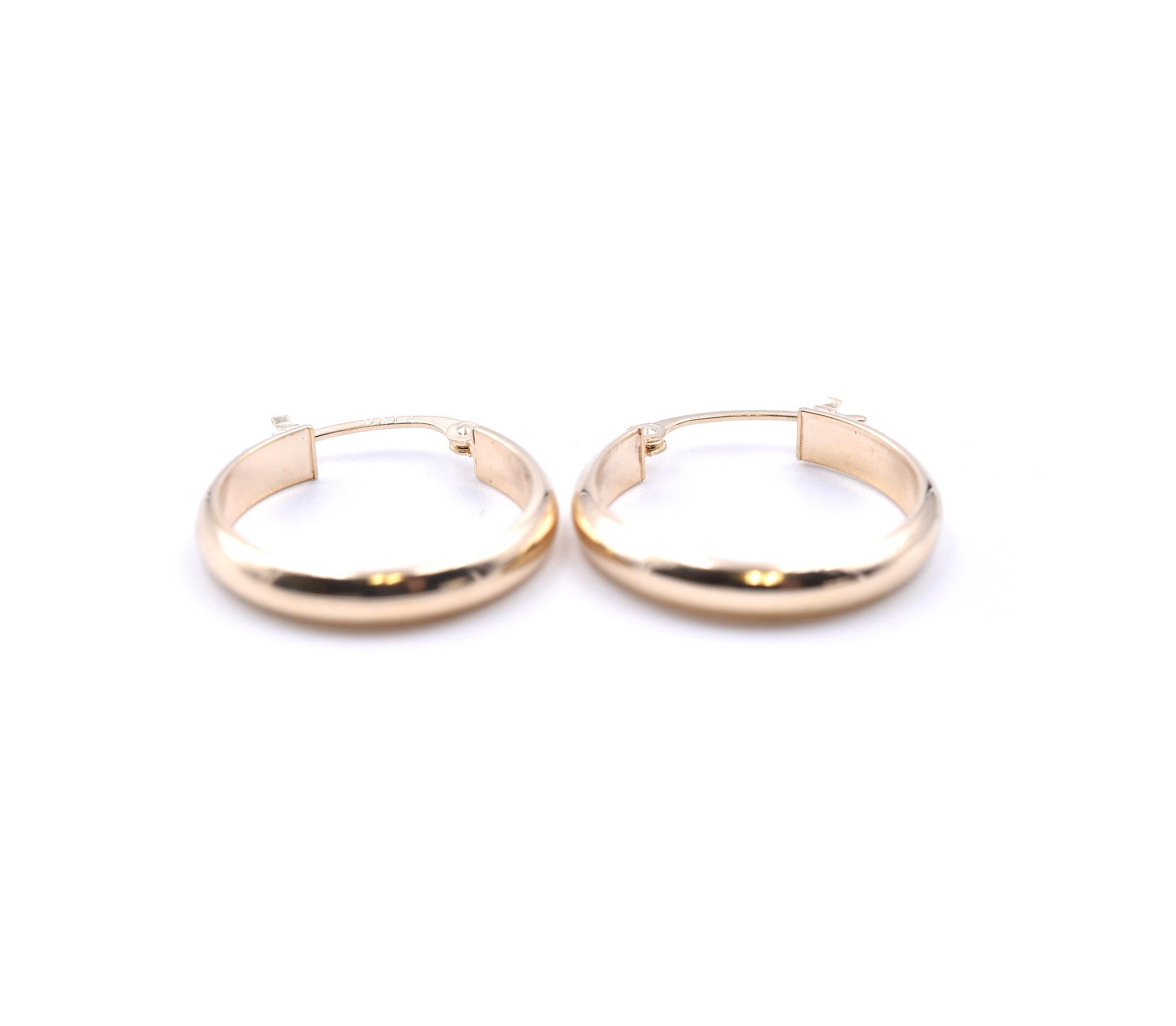 Designer: custom
Material: 14k yellow gold
Dimensions: earrings measure 17mm in diameter
Fastenings: snap closure
Weight: 1.01 grams