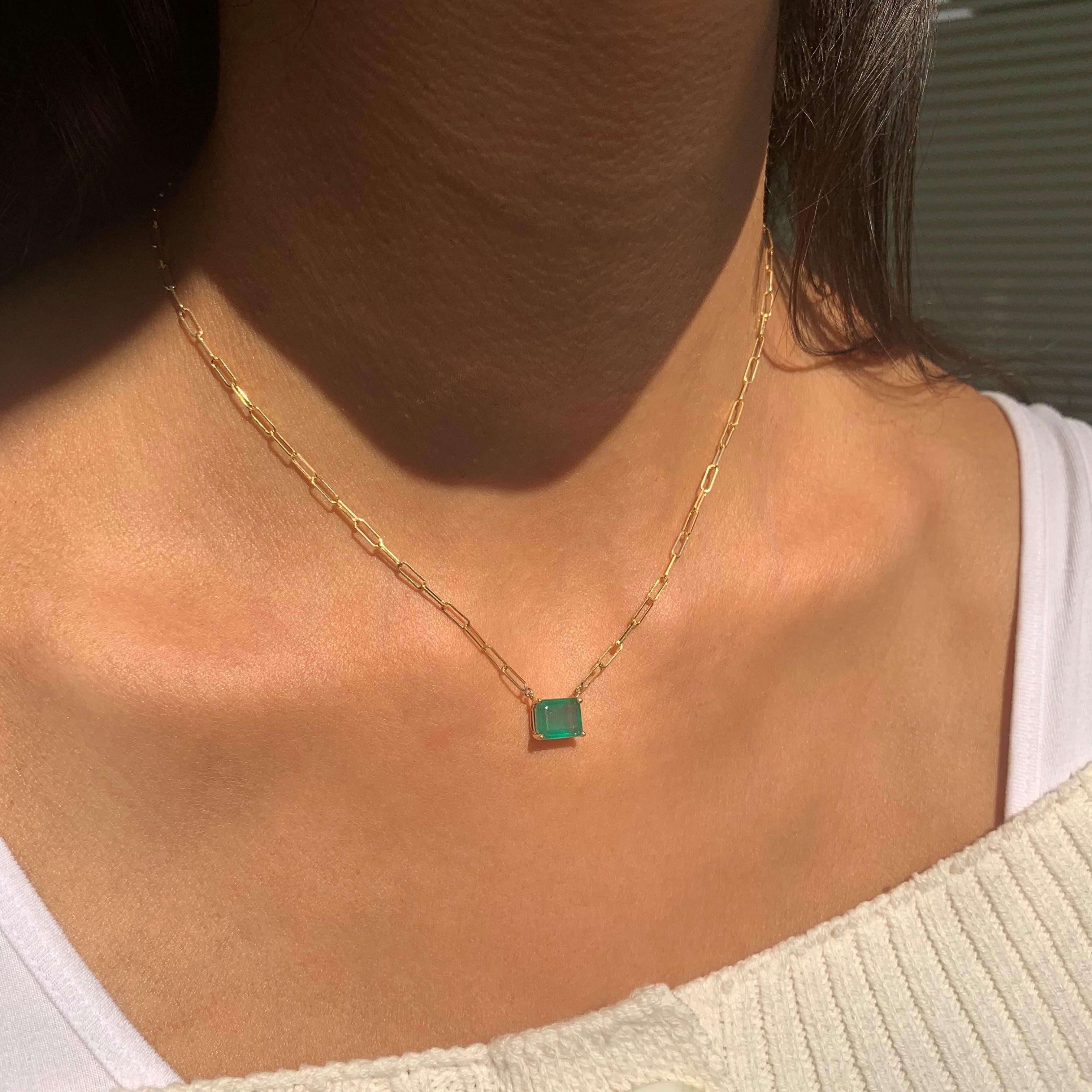This Elegant & Beautiful 14K Yellow Gold Necklace featuring a deep colored Emerald-Cut 9x7mm Emerald weighs 2 carats and is secured with 4 prongs, hangs on an 16
