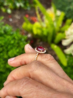 14 karat yellow Gold 3.93 Carat Oval Ruby Halo and .97 Carat Diamonds