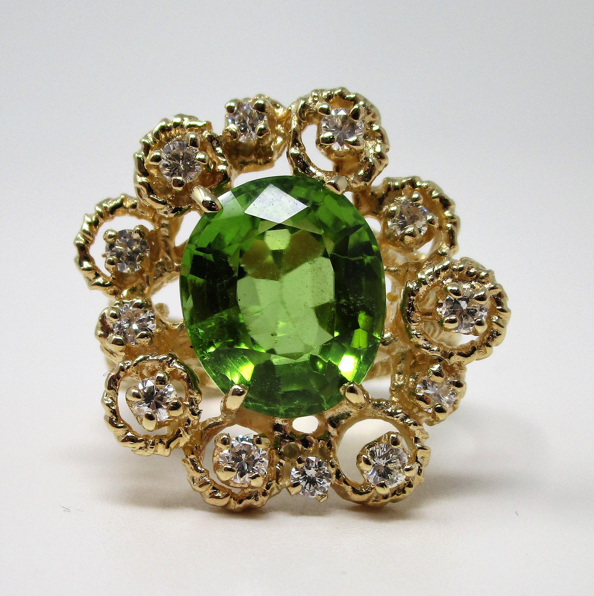 Delightful 5.52 carat peridot surrounded by 0.50 carats of diamonds in textured 14 karat yellow gold.  This cheerful ring weighs 9.5 grams and is a size 6 1/2.