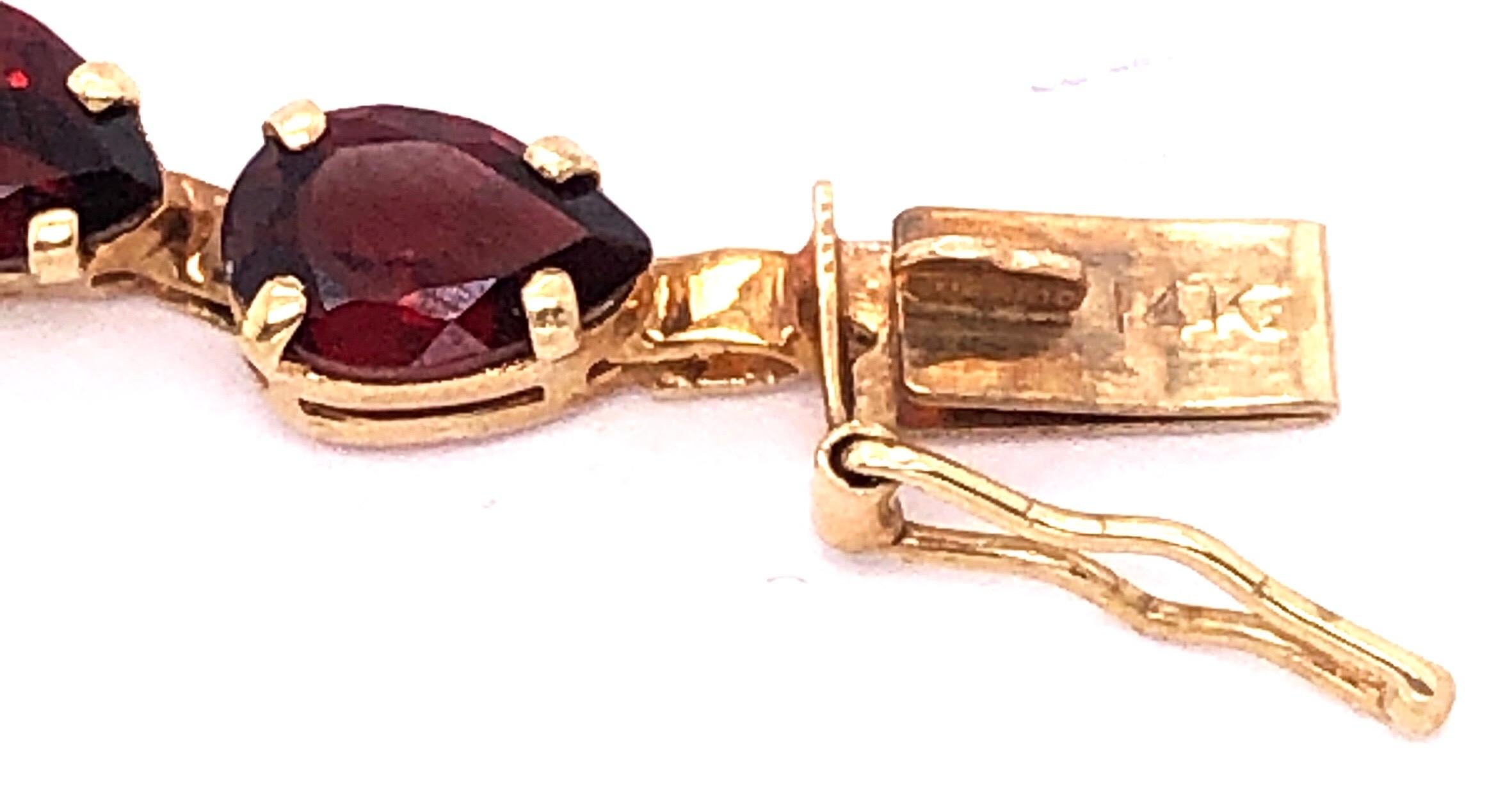 Modern 14 Karat Yellow Gold Fancy Link Garnet Bracelet Seven Inches Long For Sale