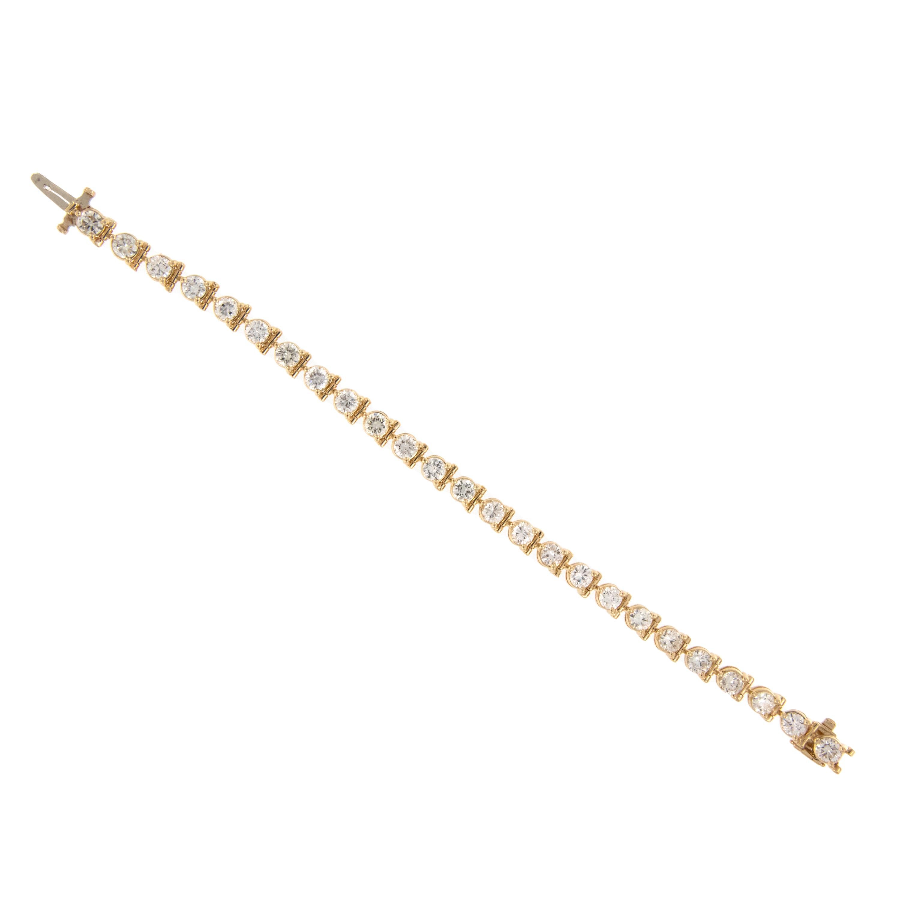 The tennis bracelet ; one of the essential staples for all, whether you are a fashionista, career woman, mom or jet setter - this bracelet is for you! Made from 14 karat yellow gold and featuring an impressive 6.75 Cttw of round brilliant cut