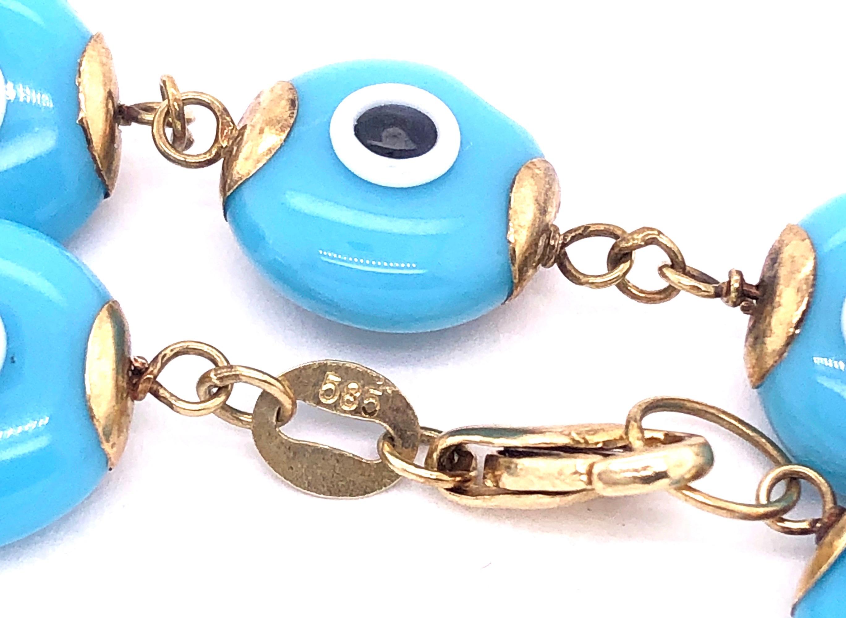 14 Karat Yellow Gold 7.5 Inch Blue Ceramic Evil Eye Charm Bracelet
9 grams total weight.
10 mm ceramic bead size