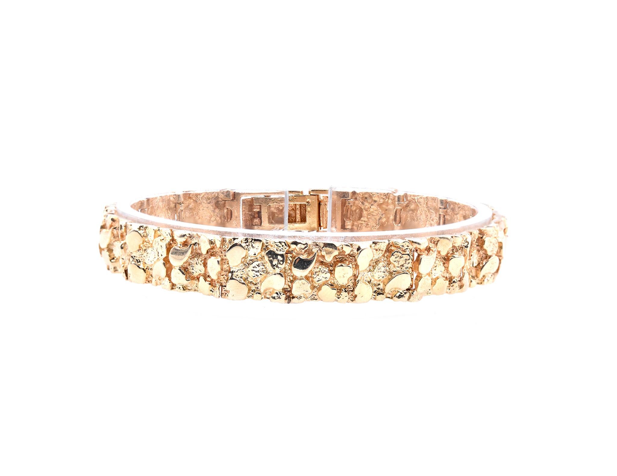 Designer: custom 
Material: 14k yellow gold
Dimensions: the bracelet will fit up to a 7.5-inch wrist, links measure 9.7mm wide
Weight: 23.3 grams