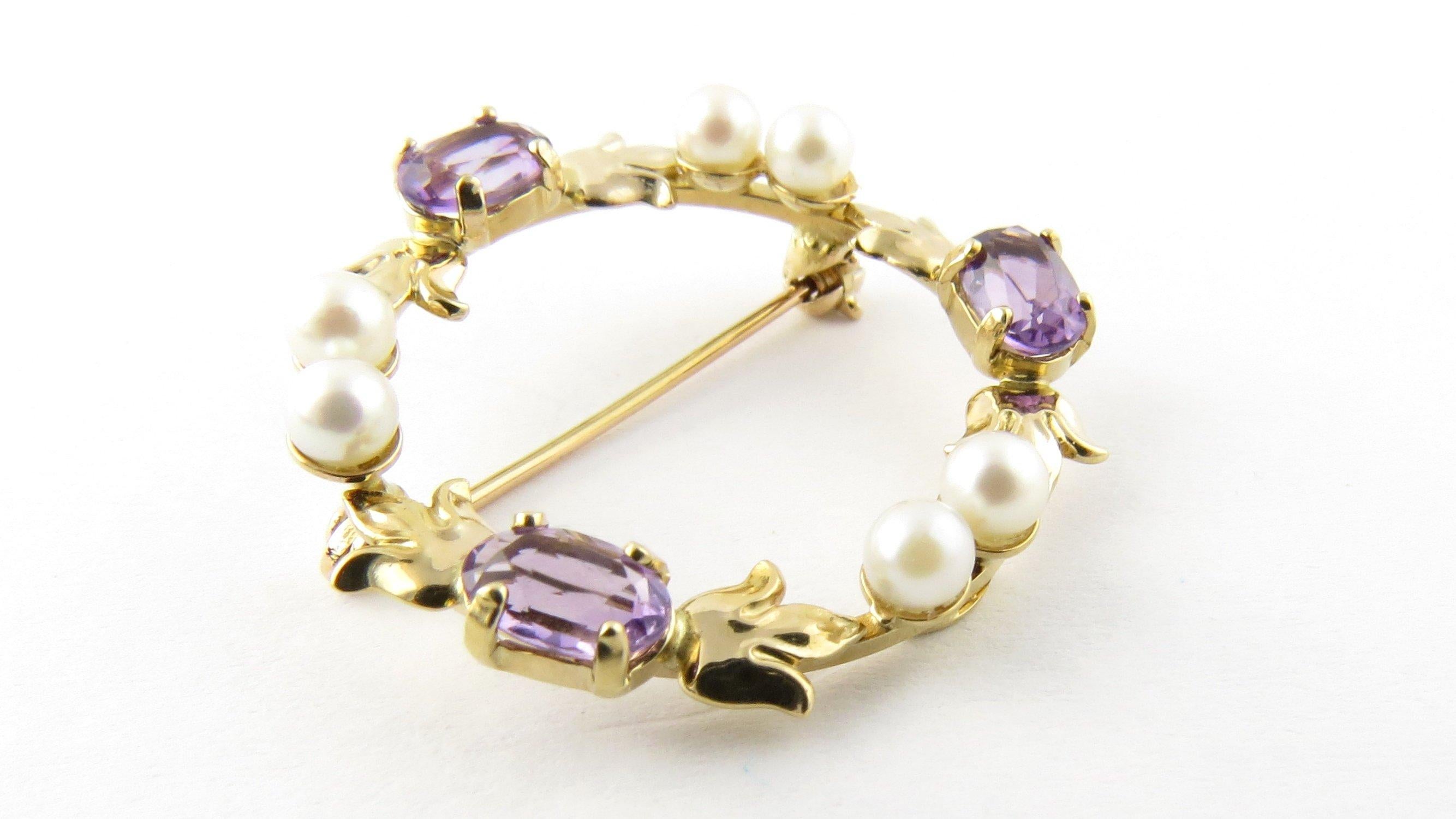Vintage 14 Karat Yellow Gold Amethyst and Pearl Pin/Brooch- 
This lovely circle pin features six cultured pearls (4 mm each) and three oval amethysts (6 mm x 4 mm) set in meticulously detailed 14K yellow gold. 
Size: 27 mm 
Weight: 2.2 dwt. / 3.5