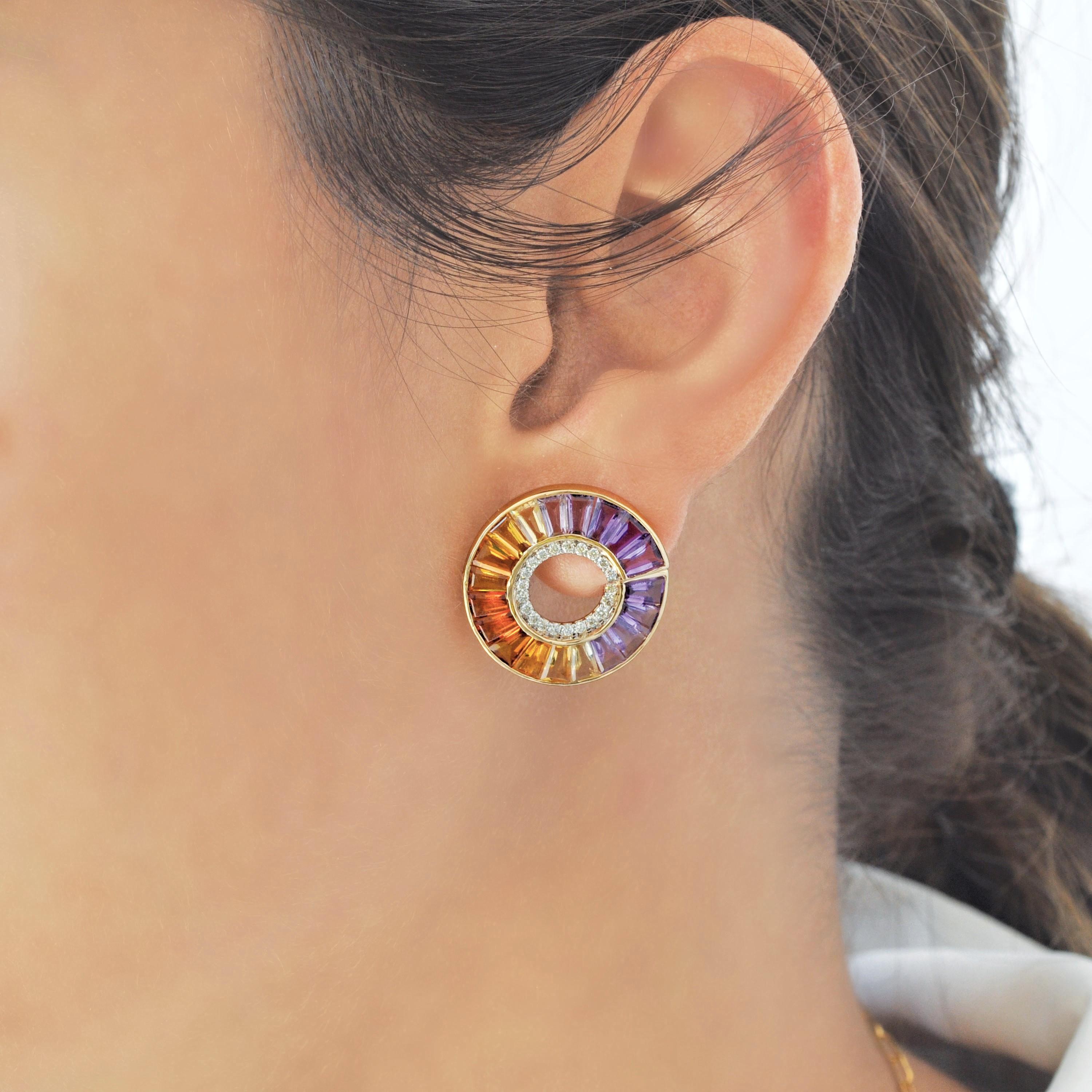 These exquisite 14K gold circular Ametrine stud earrings are a stunning display of color, depth, and precision. Designed with a seamless channel setting, each earring features a radiant blend of tapered baguette-cut amethysts and citrines, creating