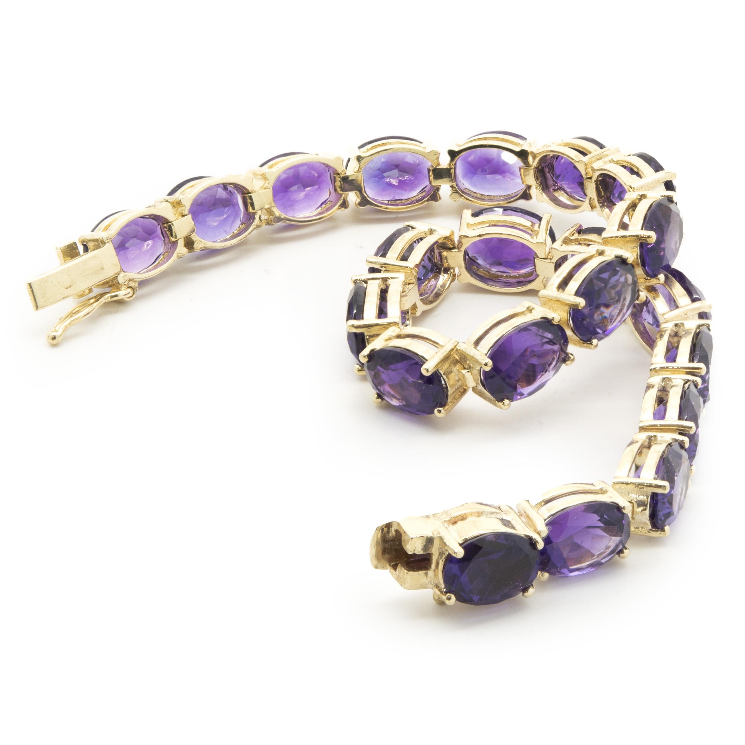 Designer: custom
Material: 14K yellow gold
Weight:  16.70 grams
Amethyst: 21 oval  cut = 22.26cttw
Dimensions: bracelet will fit up to a 7-inch wrist
